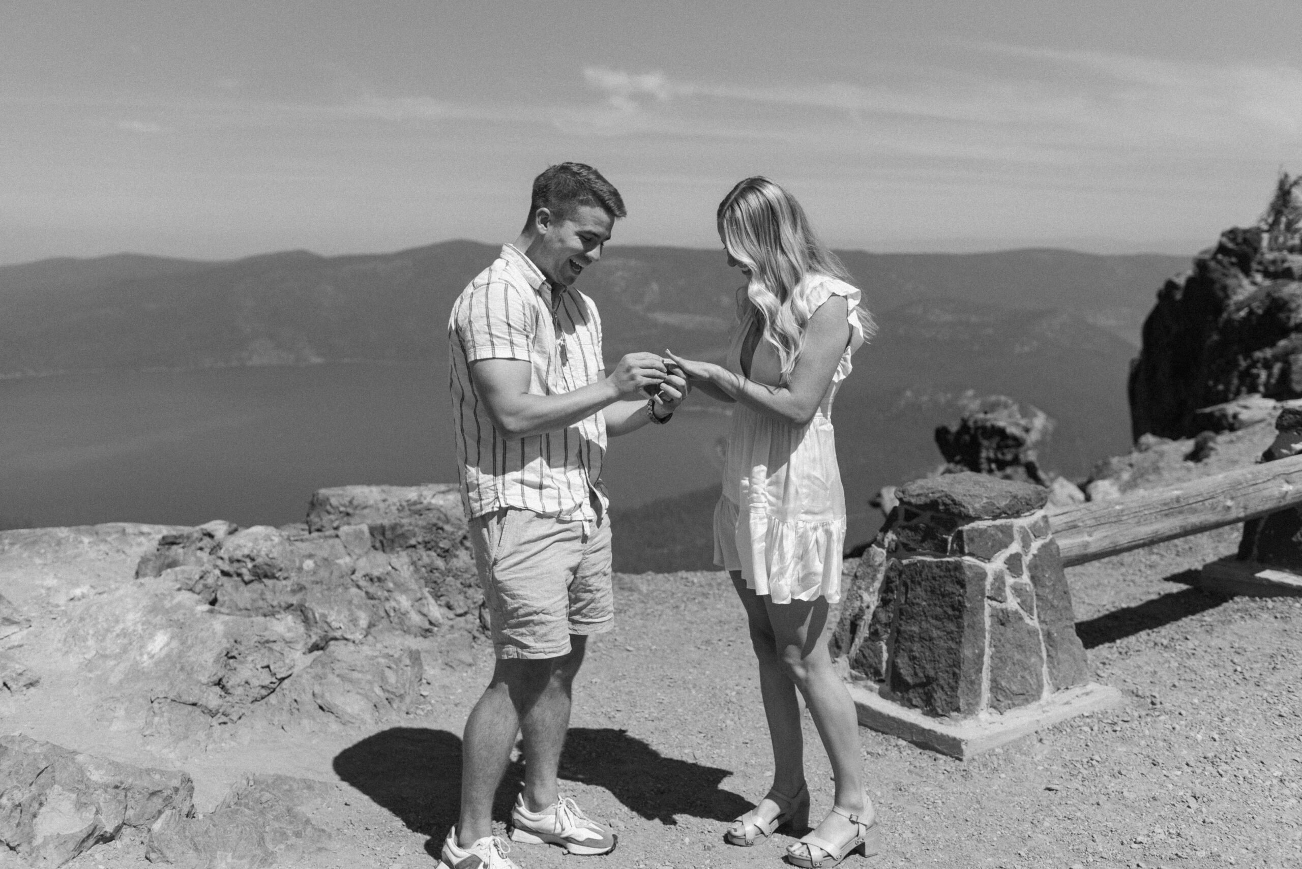 black and white of connor putting the ring on laura