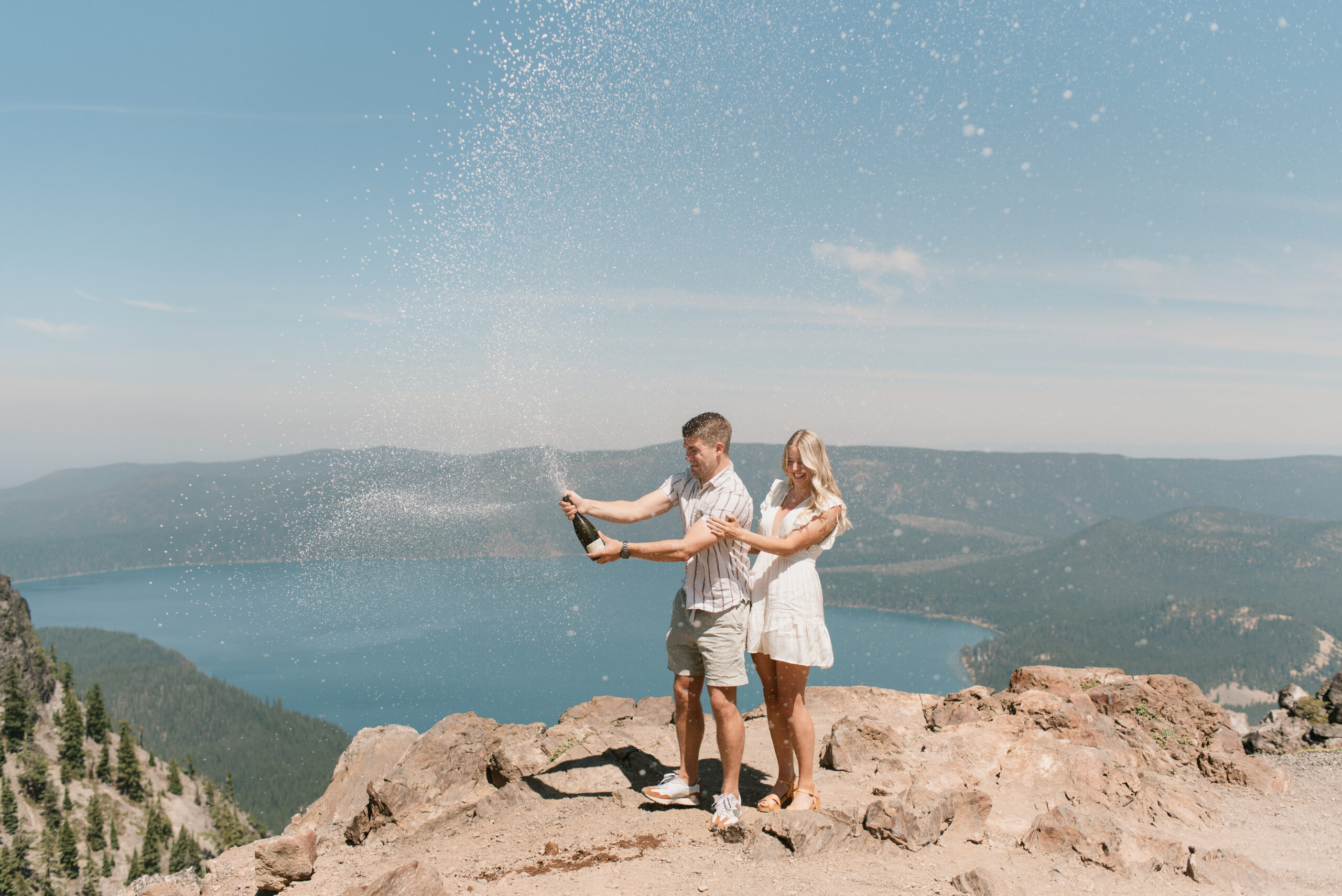 laura and connor popping champagne  after oregon proposal 