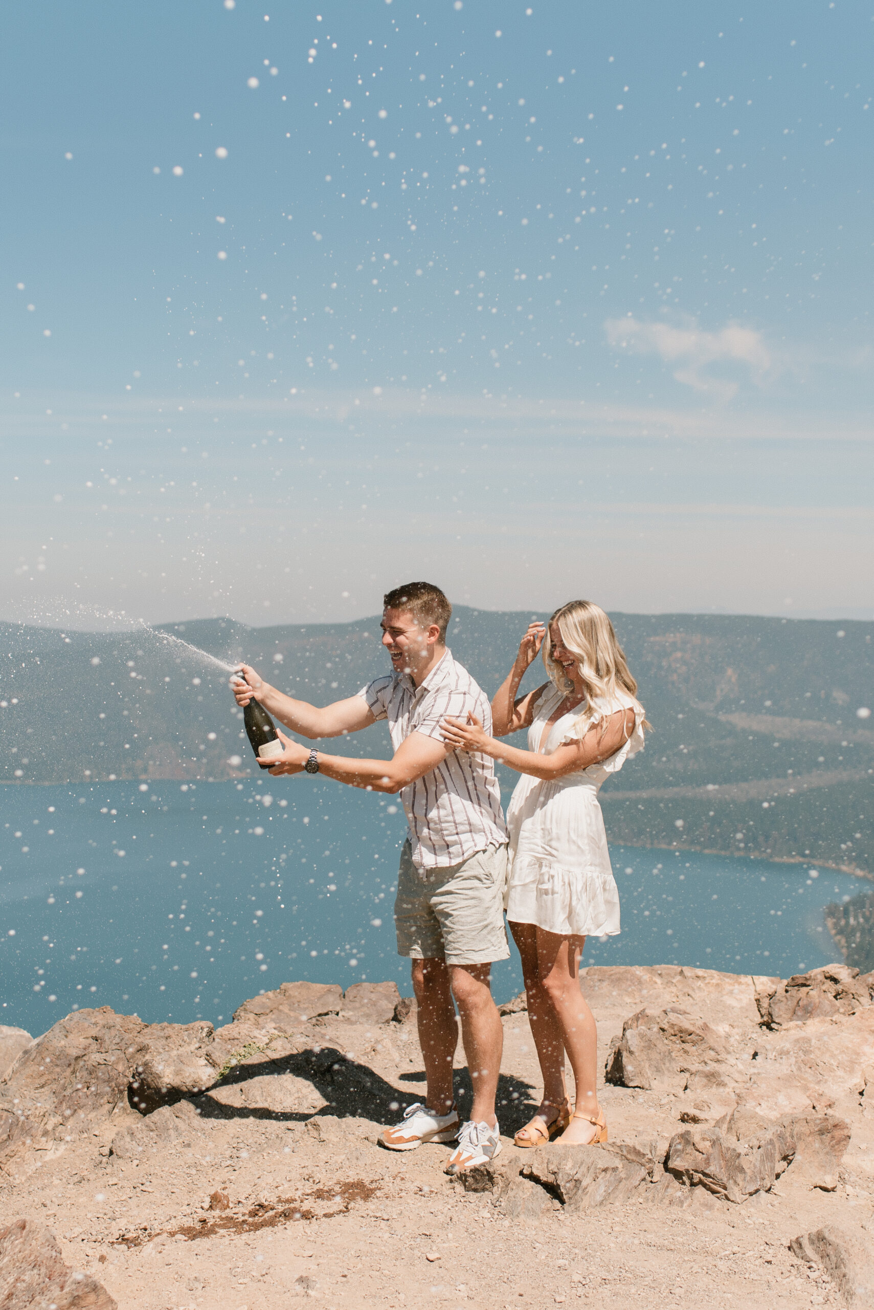 laura and connor popping champagne  after oregon proposal 