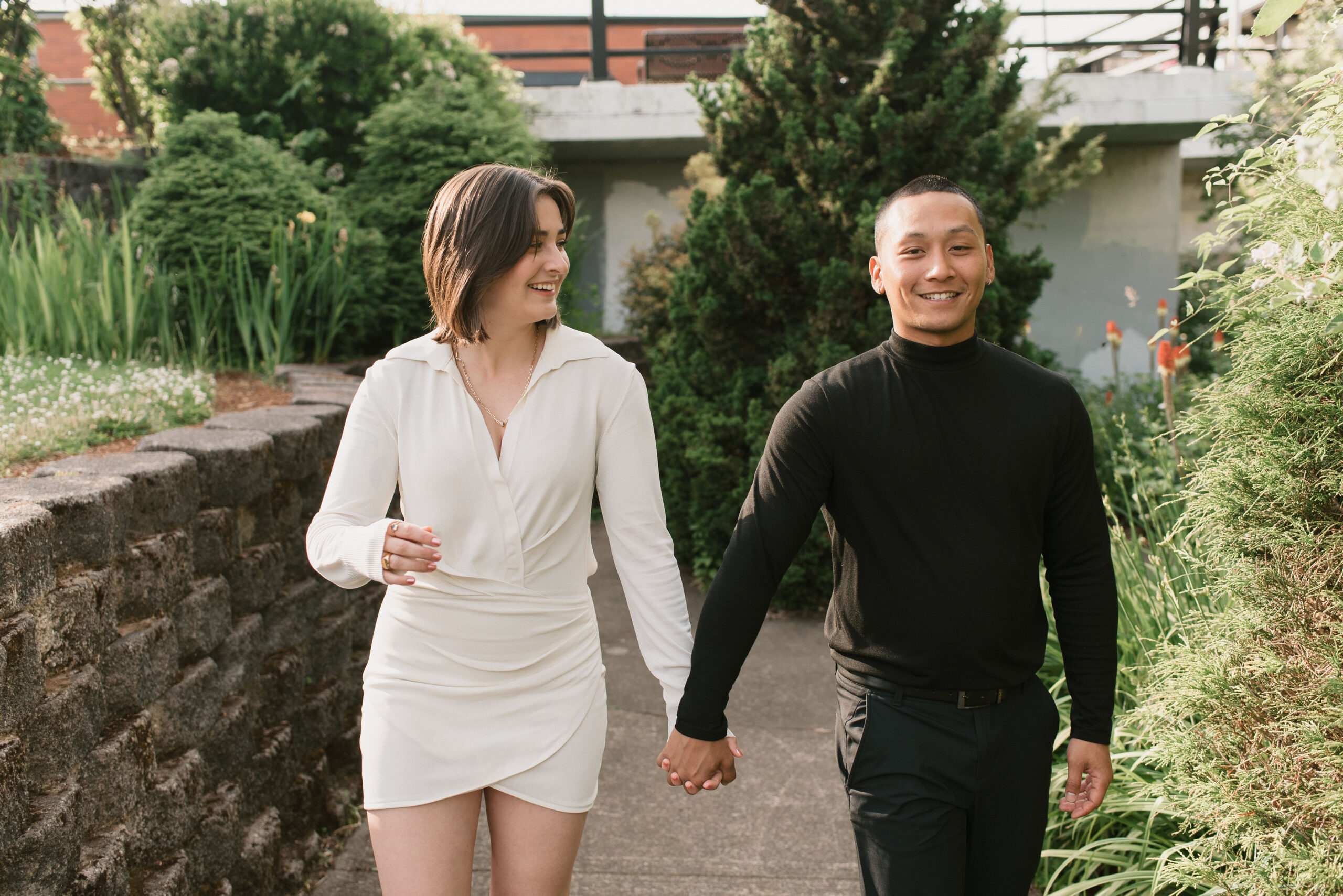 couple smiling, walking together holding hand at editorial couple photoshoot 