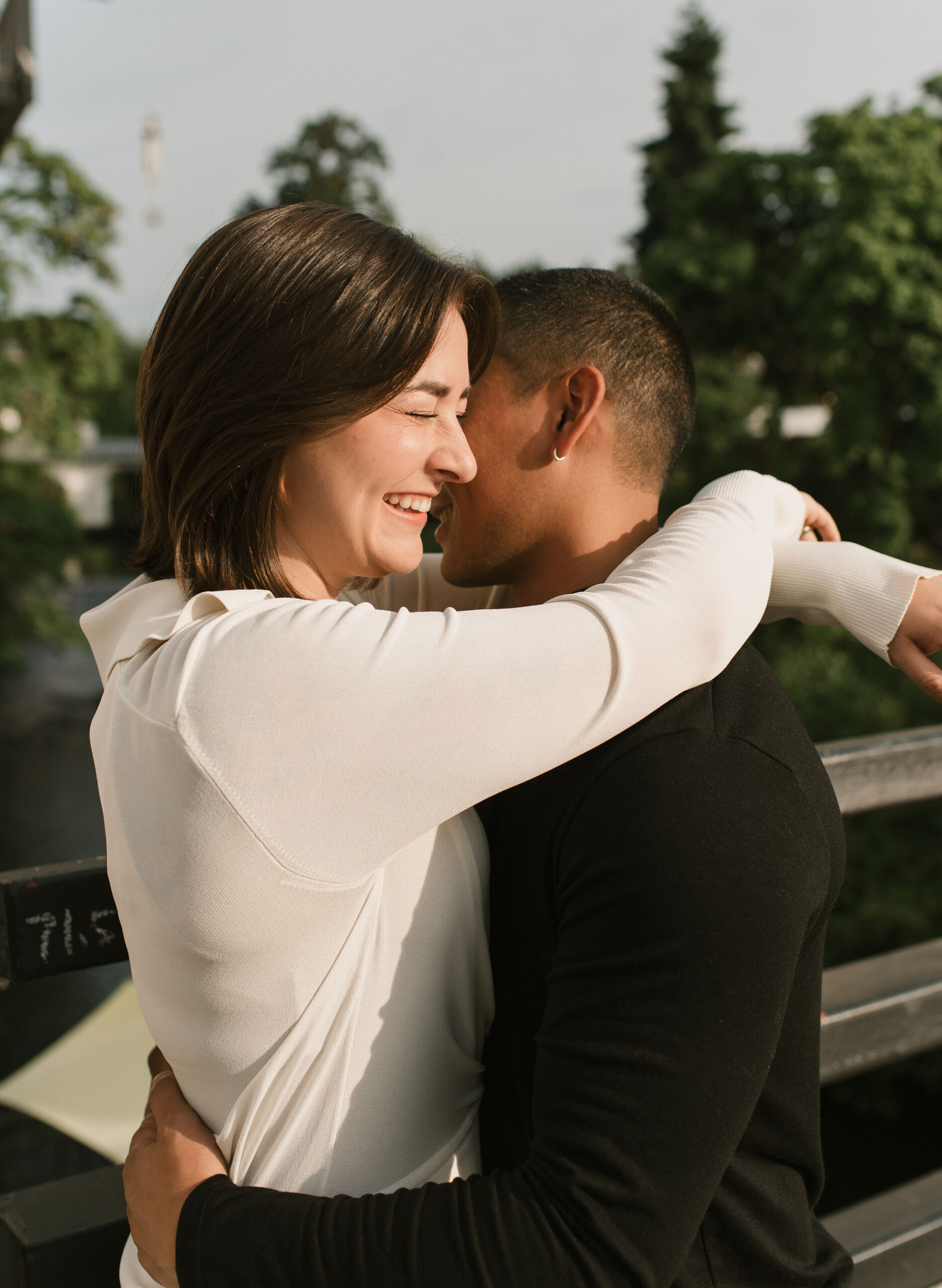 couple holding each other and laughing on the bridge 