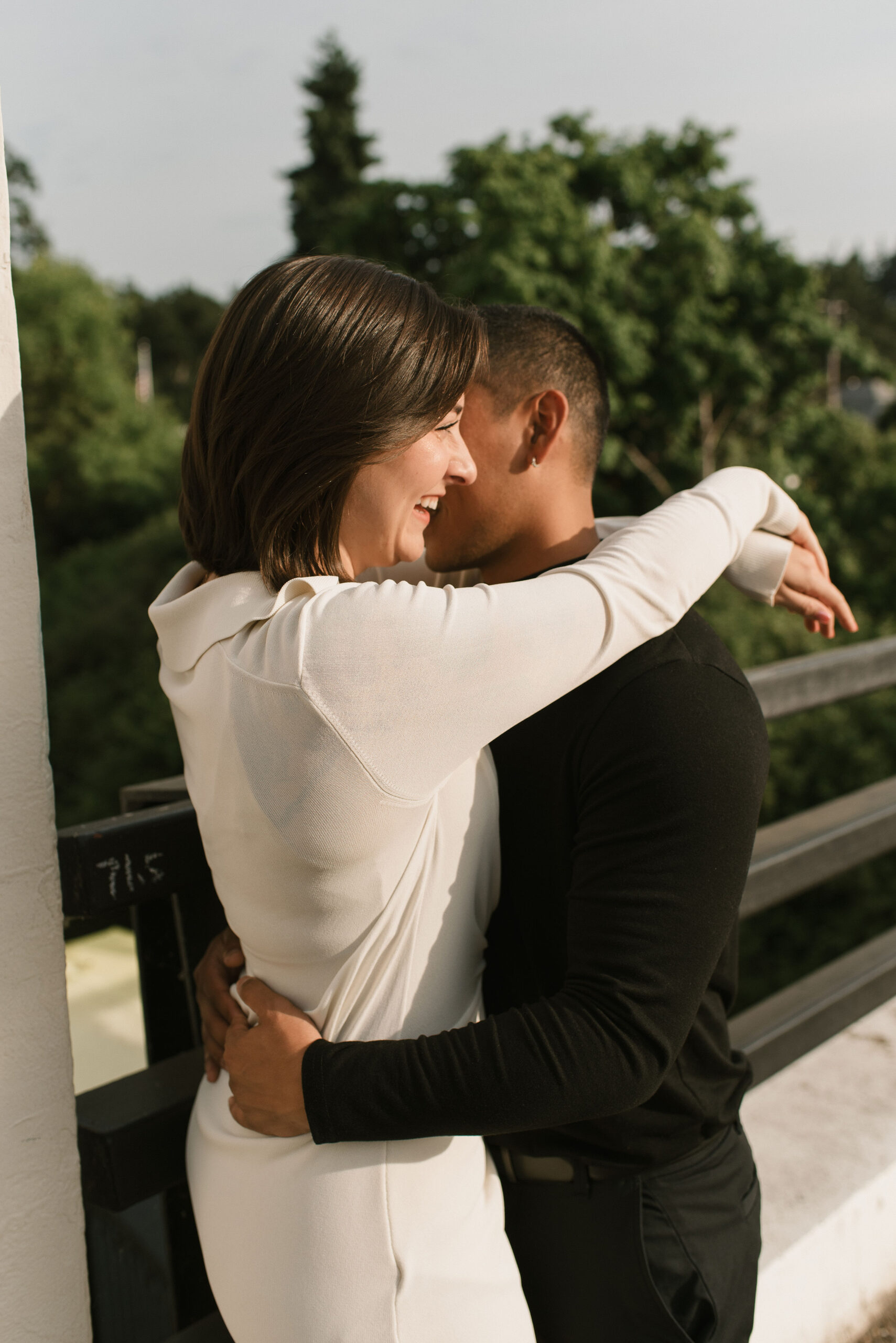 couple holding each other and laughing on the bridge 