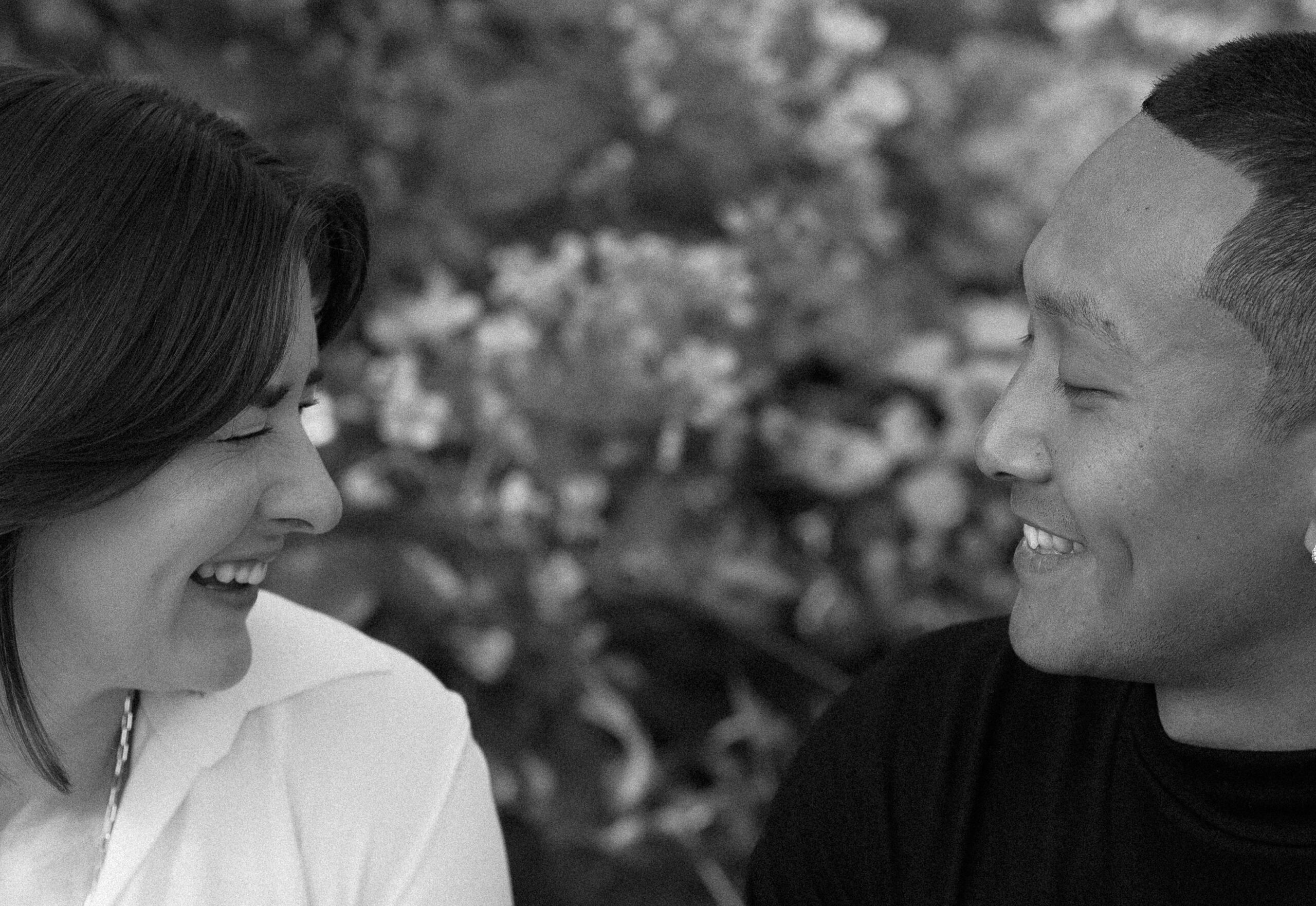 black and white of couples faces laughing with each other