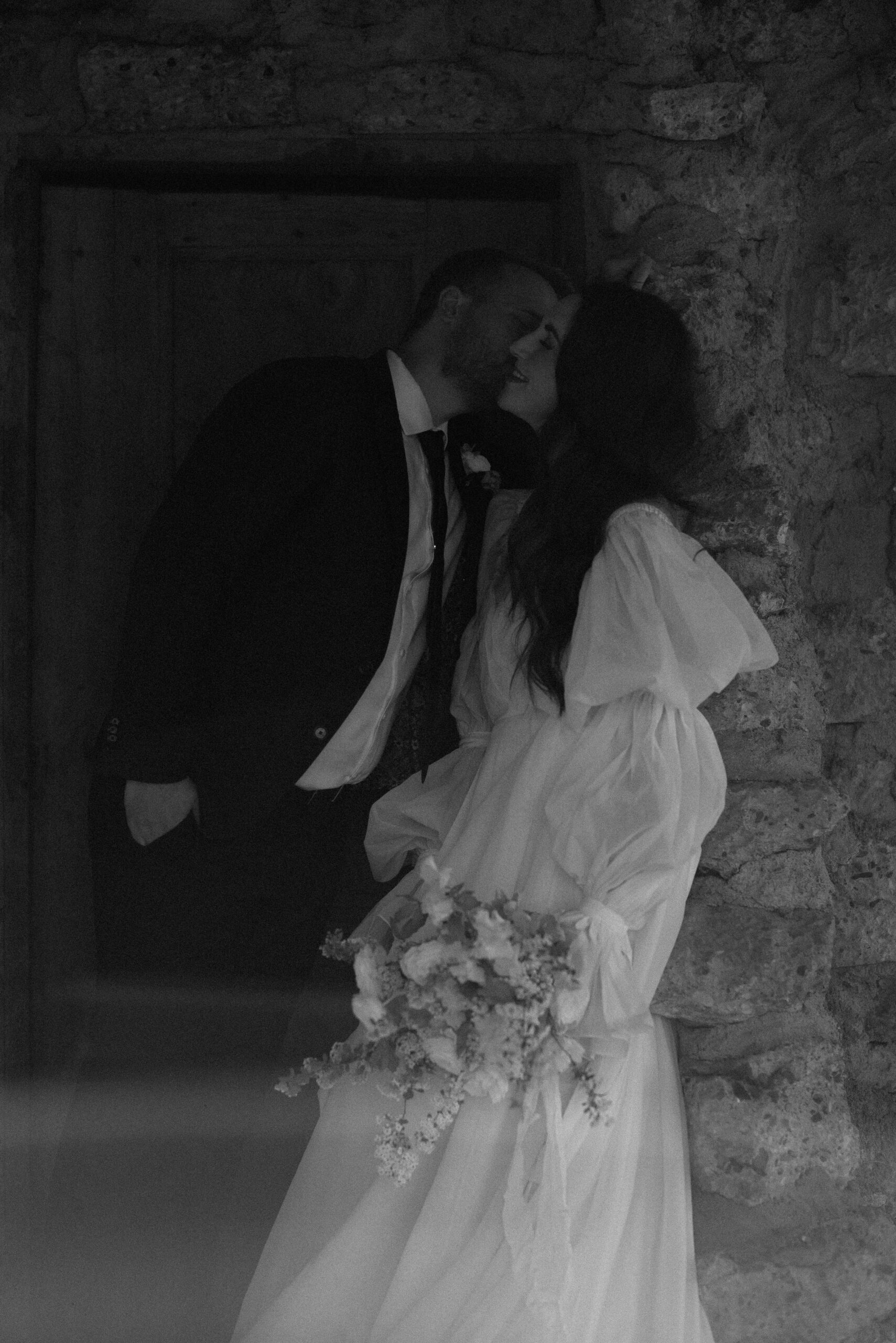 black and white bride and groom kissing at european-inspired wedding venue 