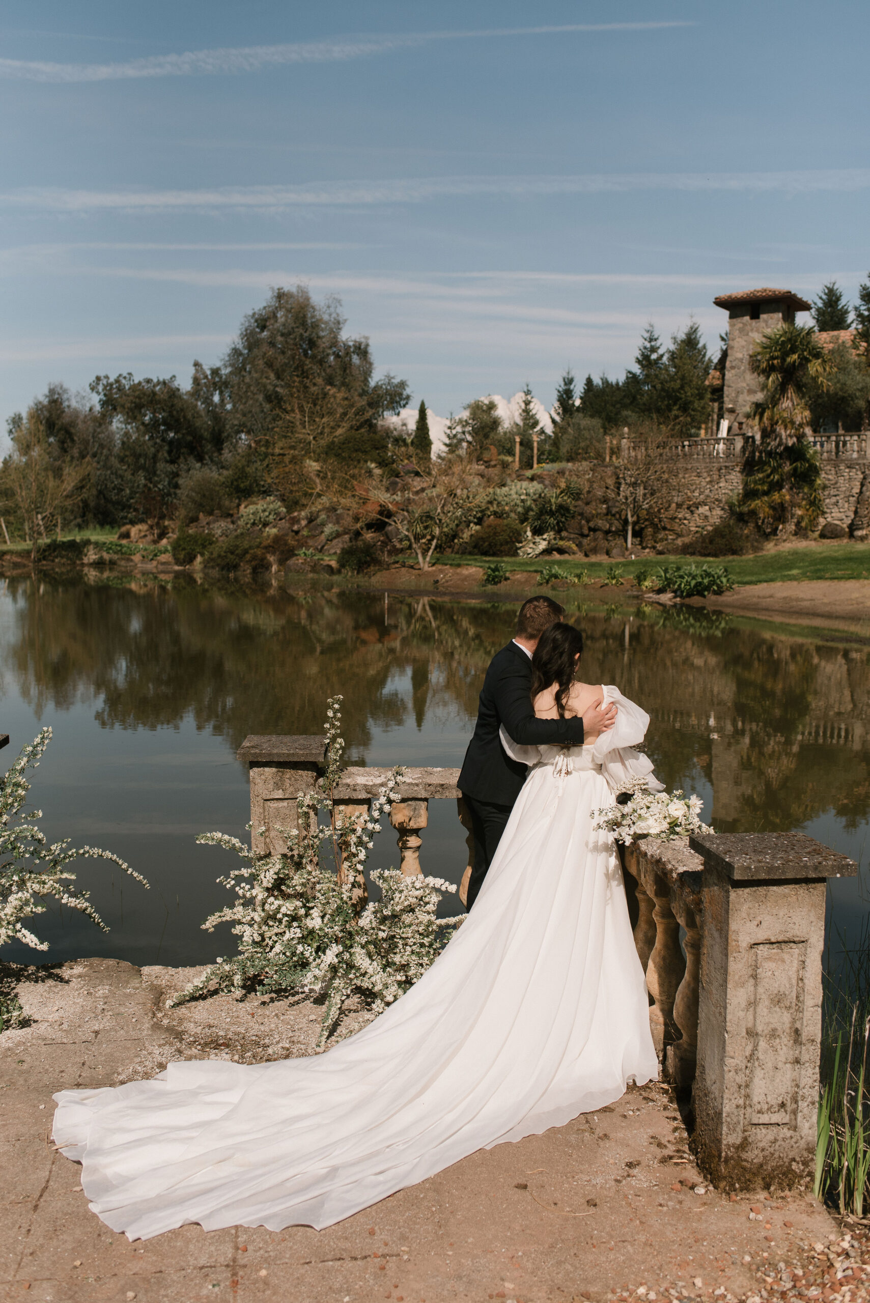 bride and groom by the water at european-inspired wedding venue 