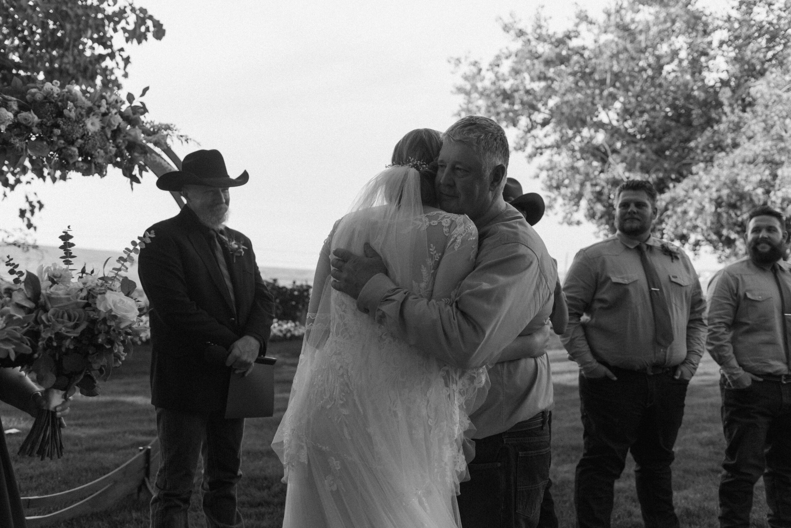 candid wedding photography of bride and dad hugging
