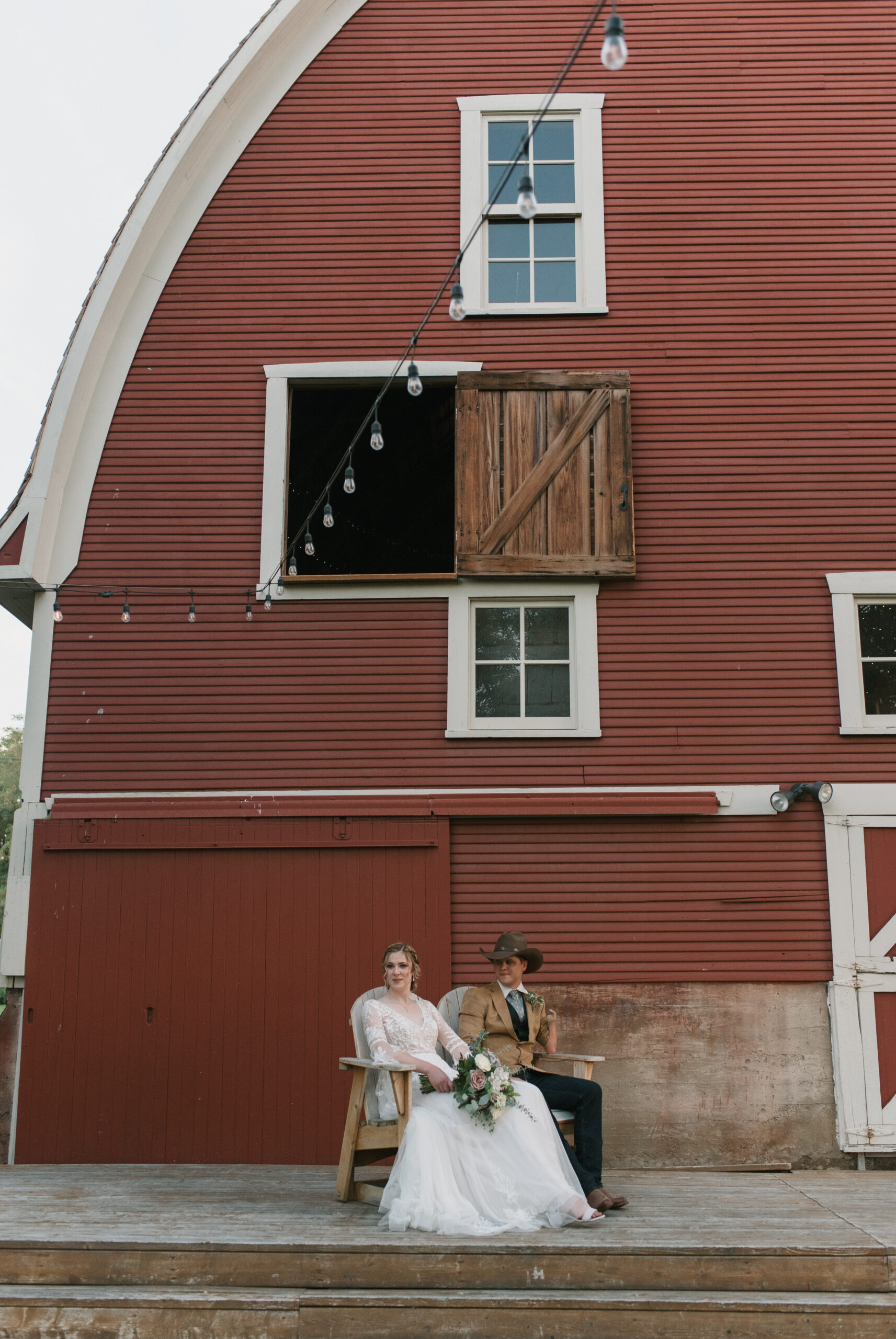 bride and groom portrait in front of the barn wedding venue 
