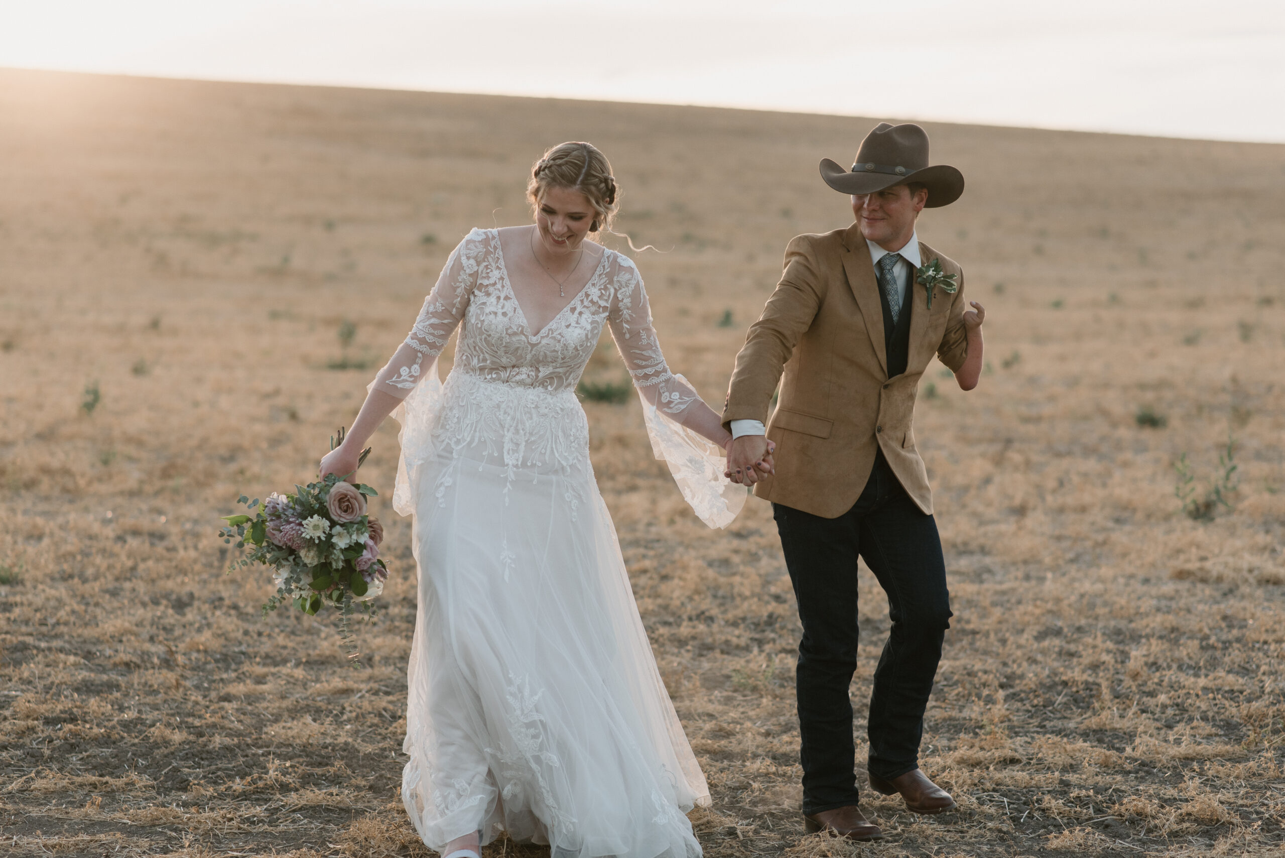 candid wedding photography of bride and groom walking and laughing 