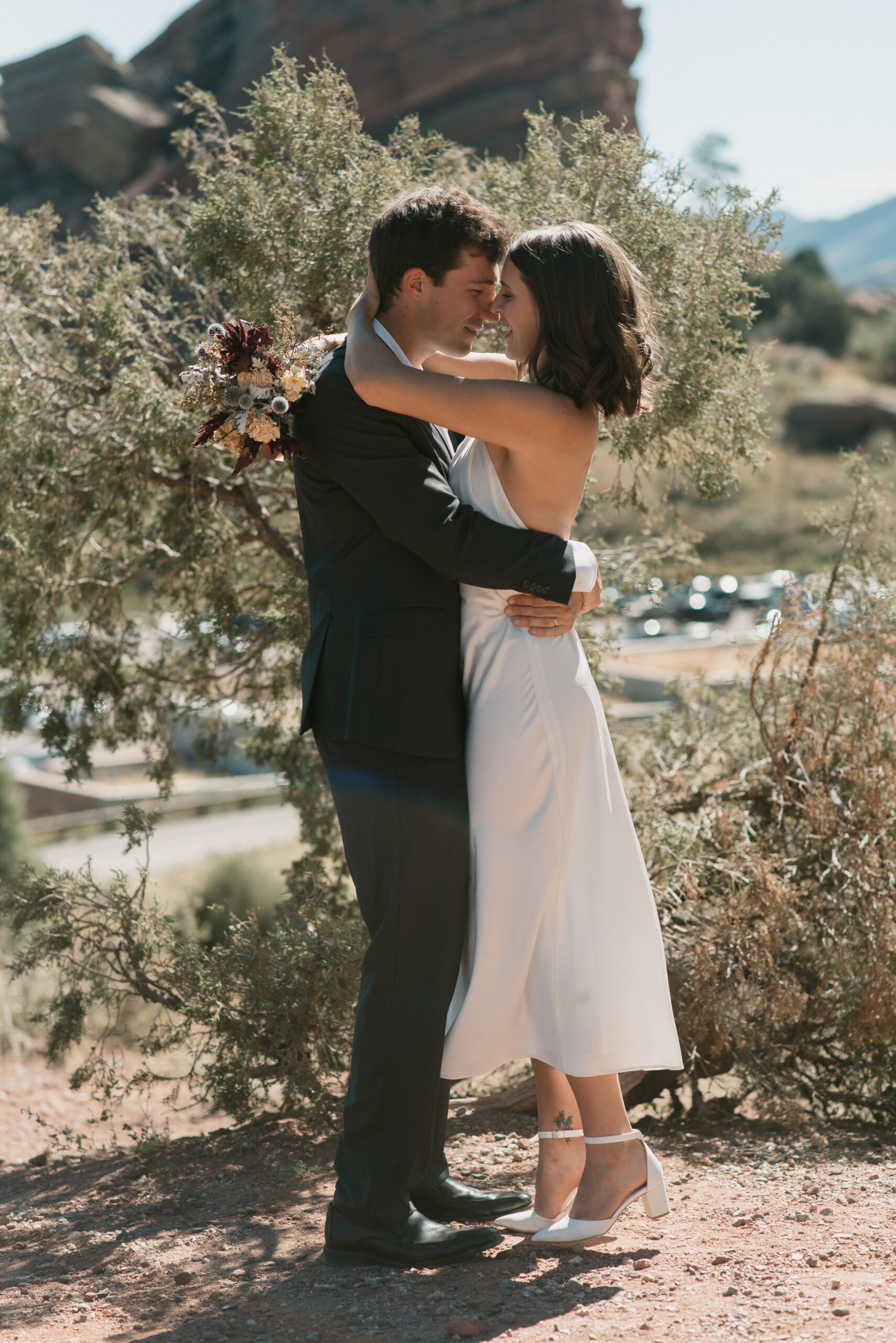 bridal couple holding each other and touching noses at colorado elopement 