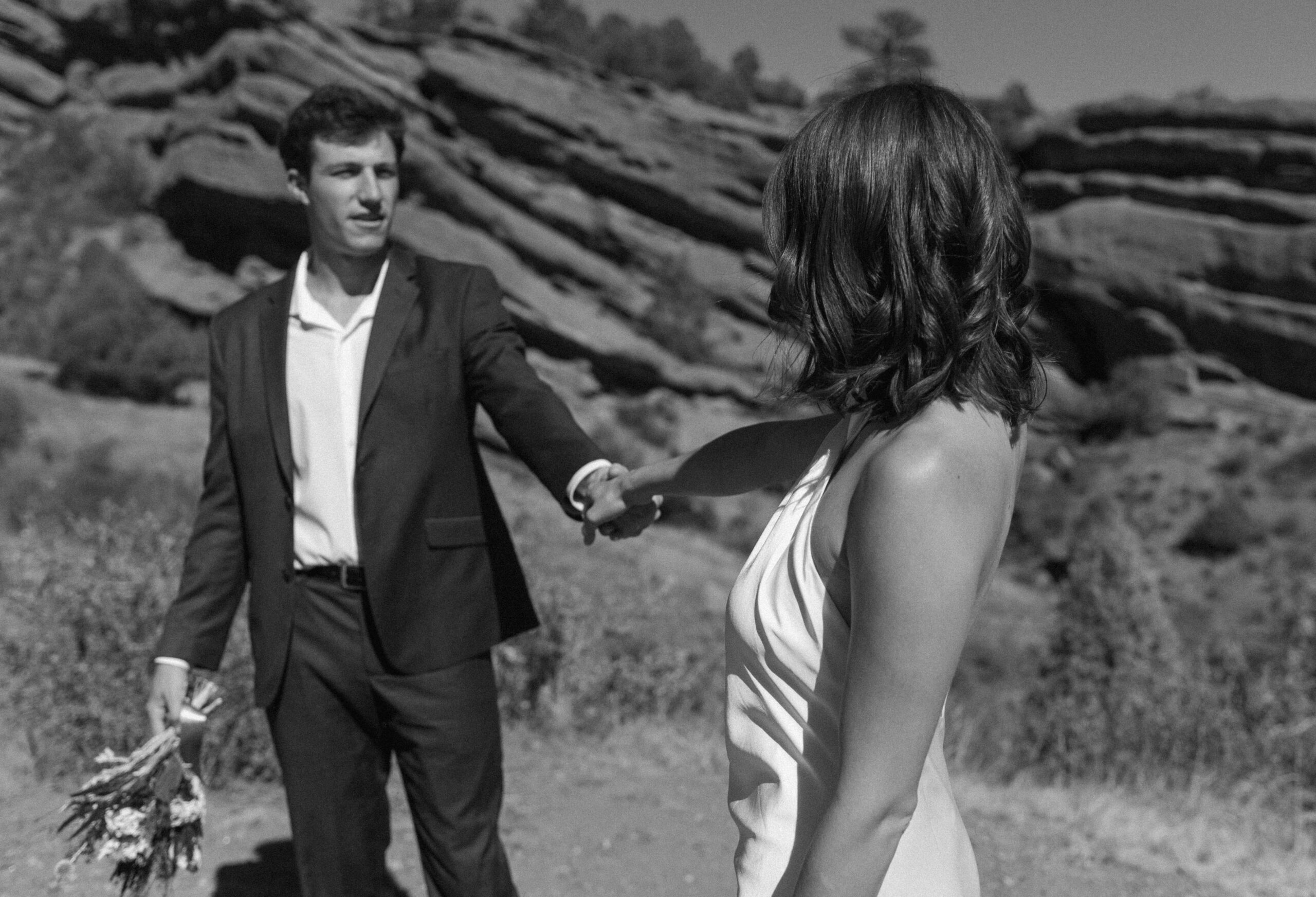 bridal couples holding hands and looking at each other at colorado elopement 