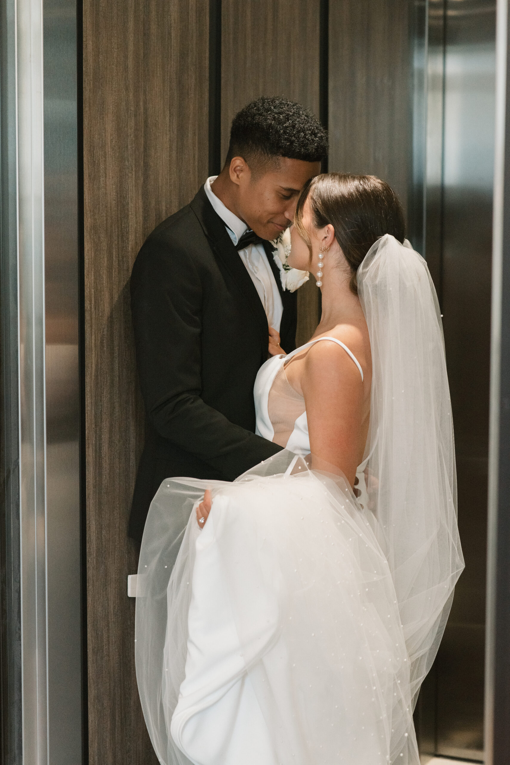 bride an groom in elevator 
