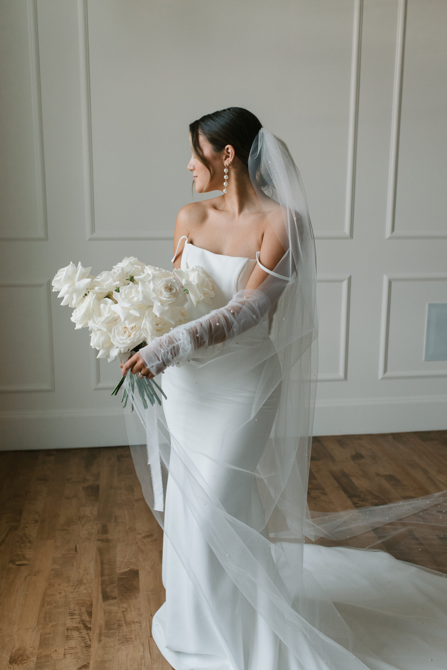 editorial bridal portrait with sheer wedding gloves and all white bouquet