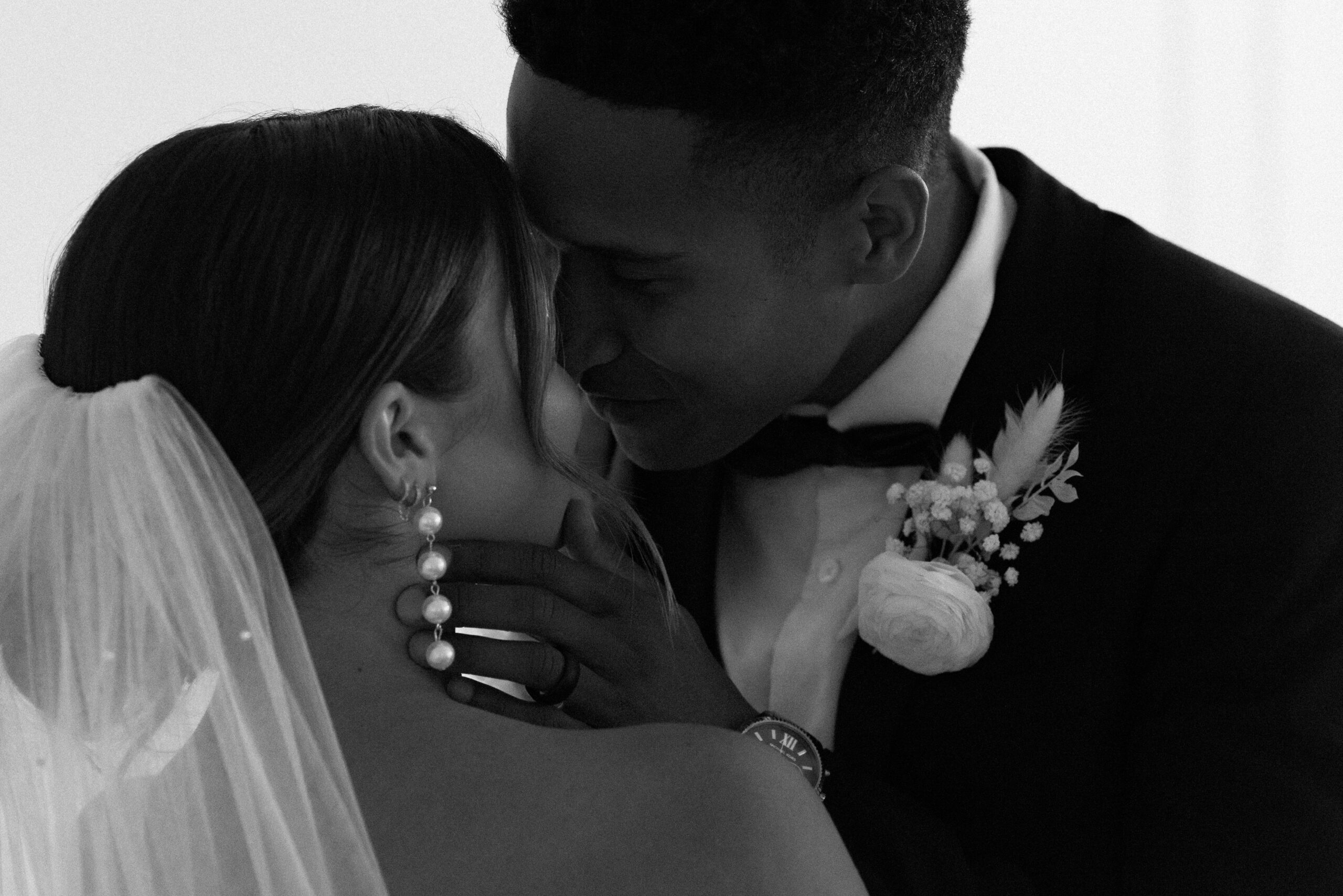 black and white of bridal couple kissing