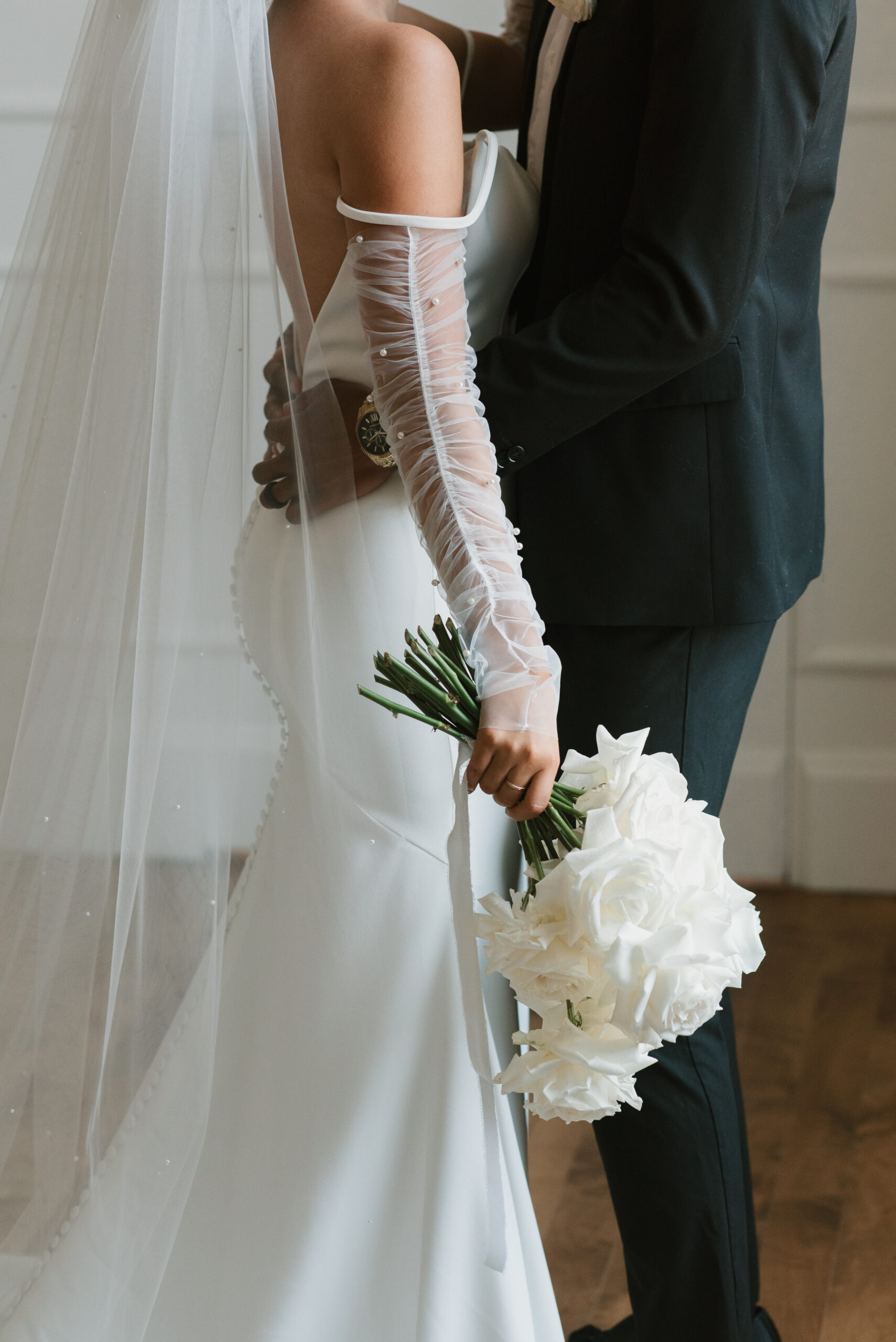 aesthetic photo of bridal couple from the shoulders down 
