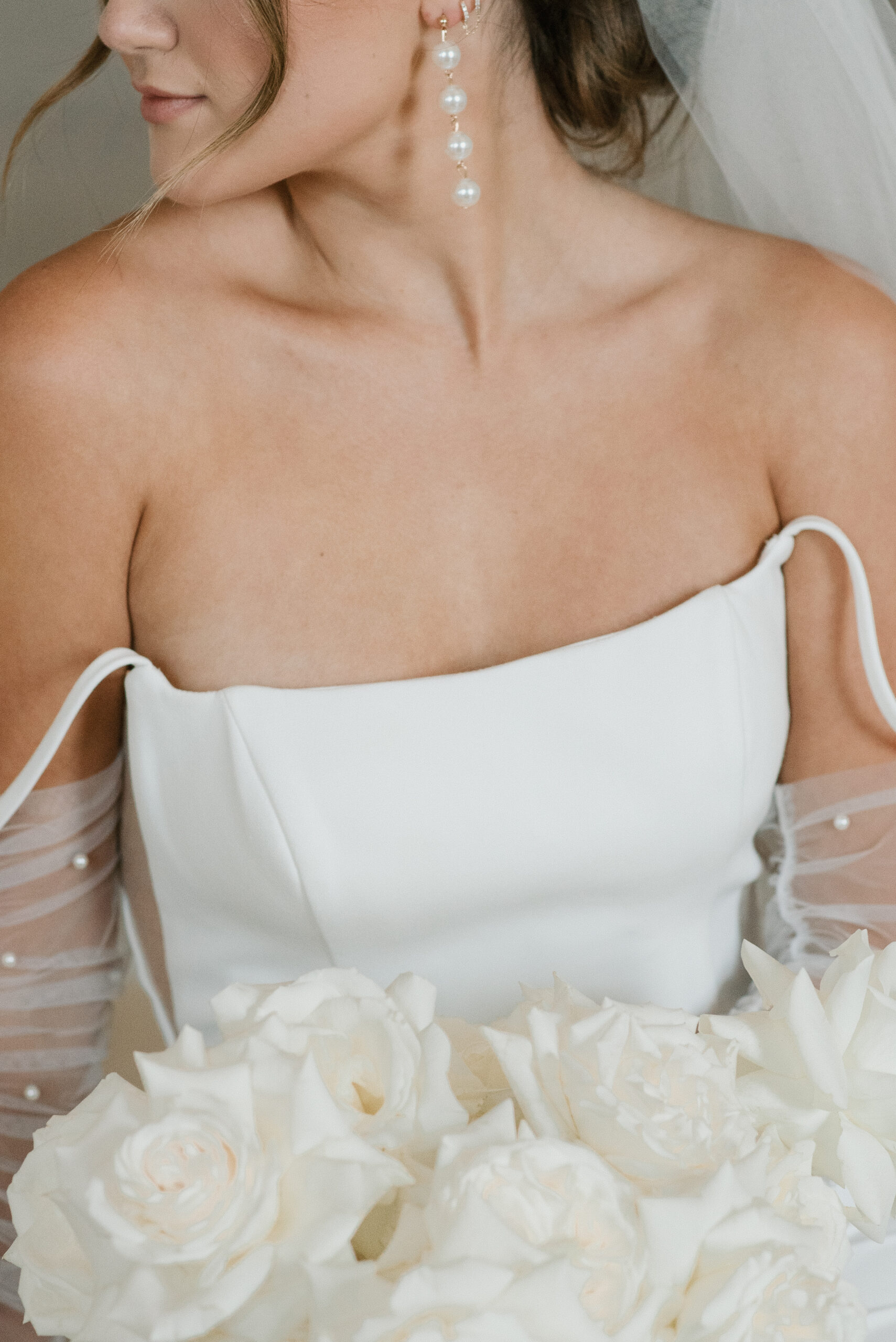 bridal detail shot of dress, earrings, gloves