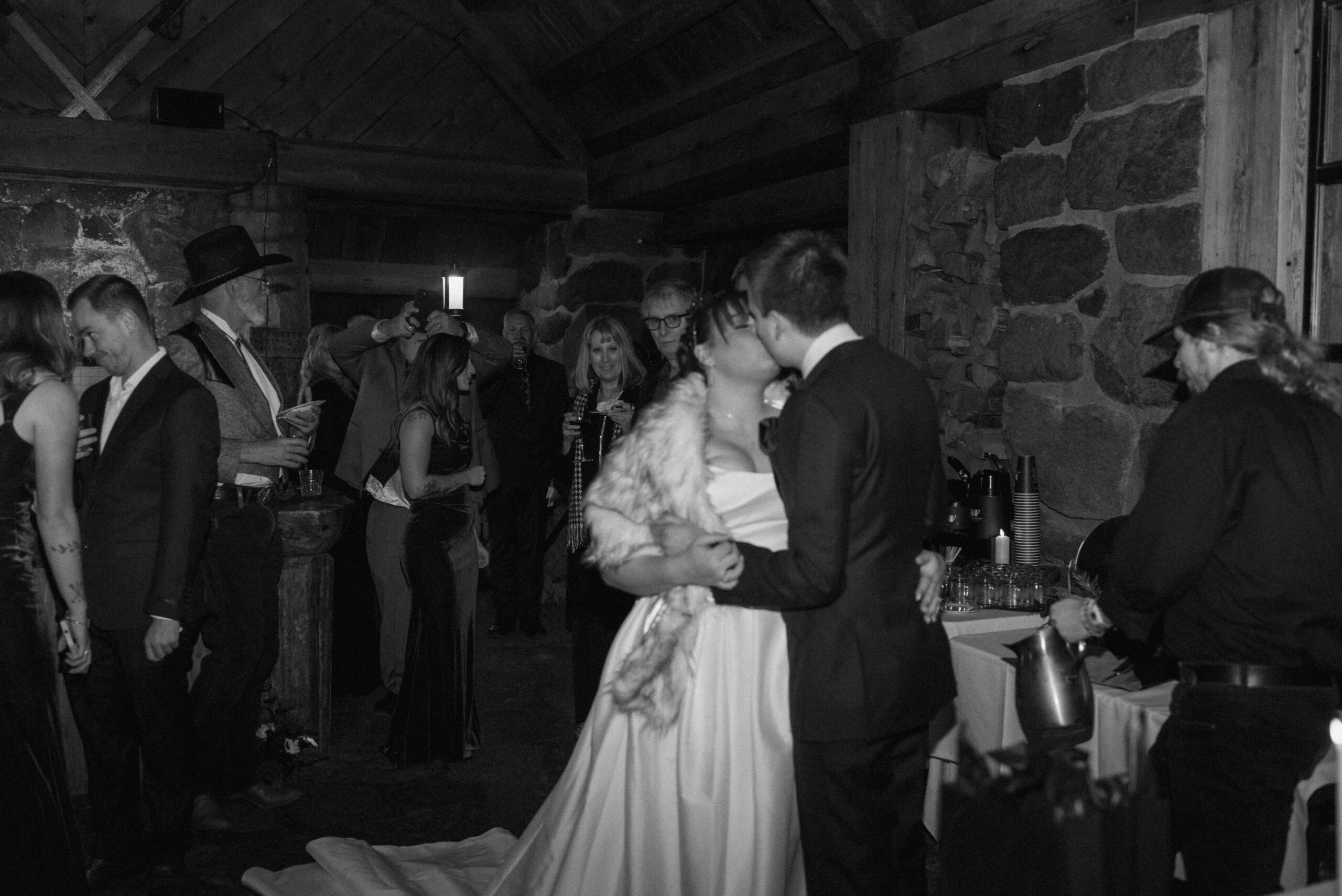 black and white of bride and groom kissing at small unique wedding 