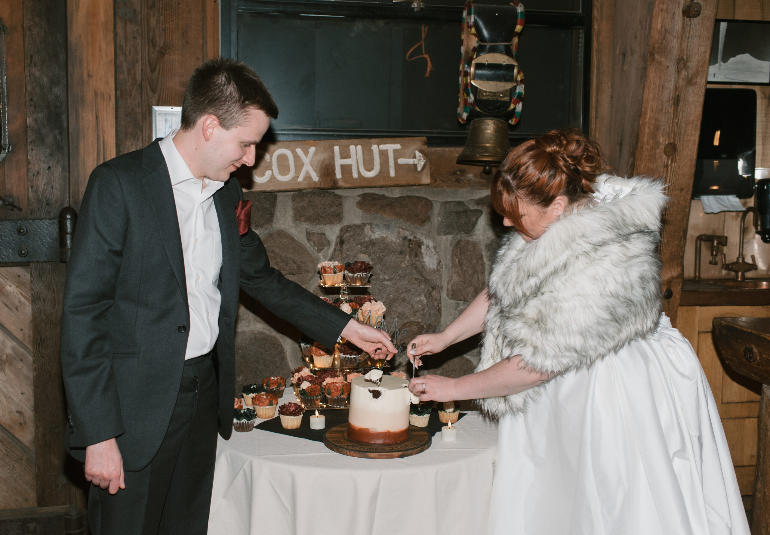 bride and groom cutting cakes at small unique wedding 