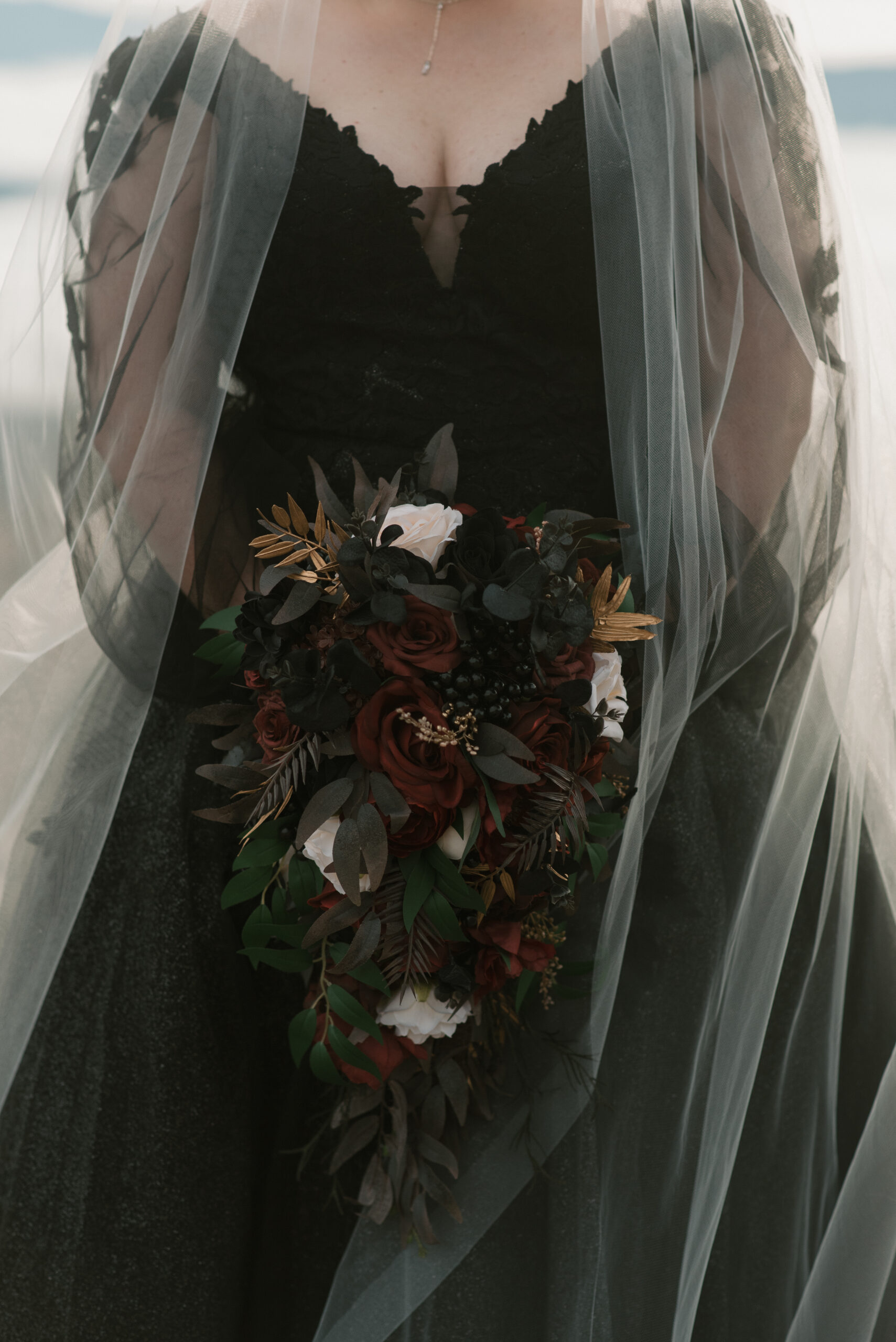 close up of wedding flowers and black dress