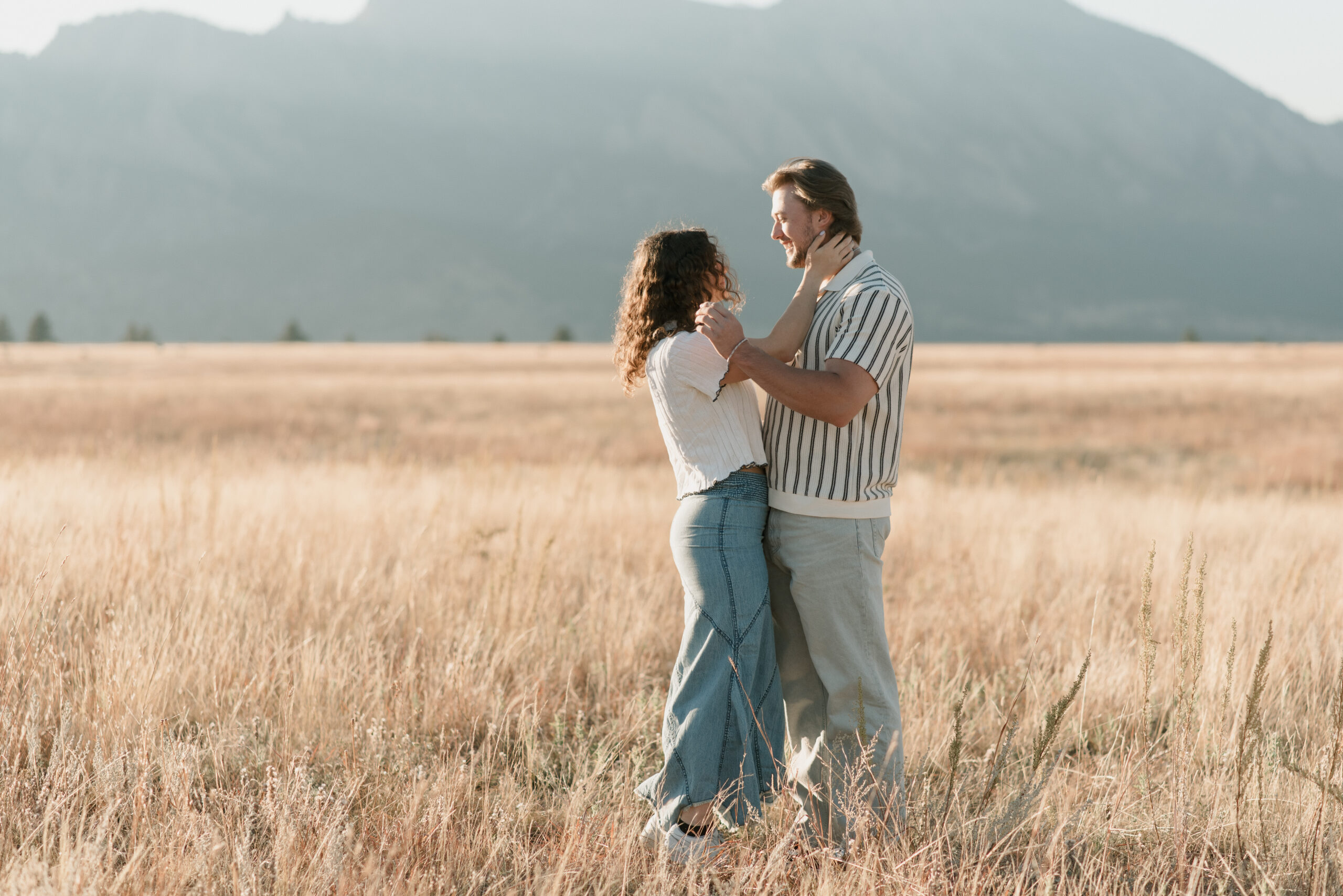 a couple during their couples photoshoot in Colorado holding each others faces and looking at each other 
