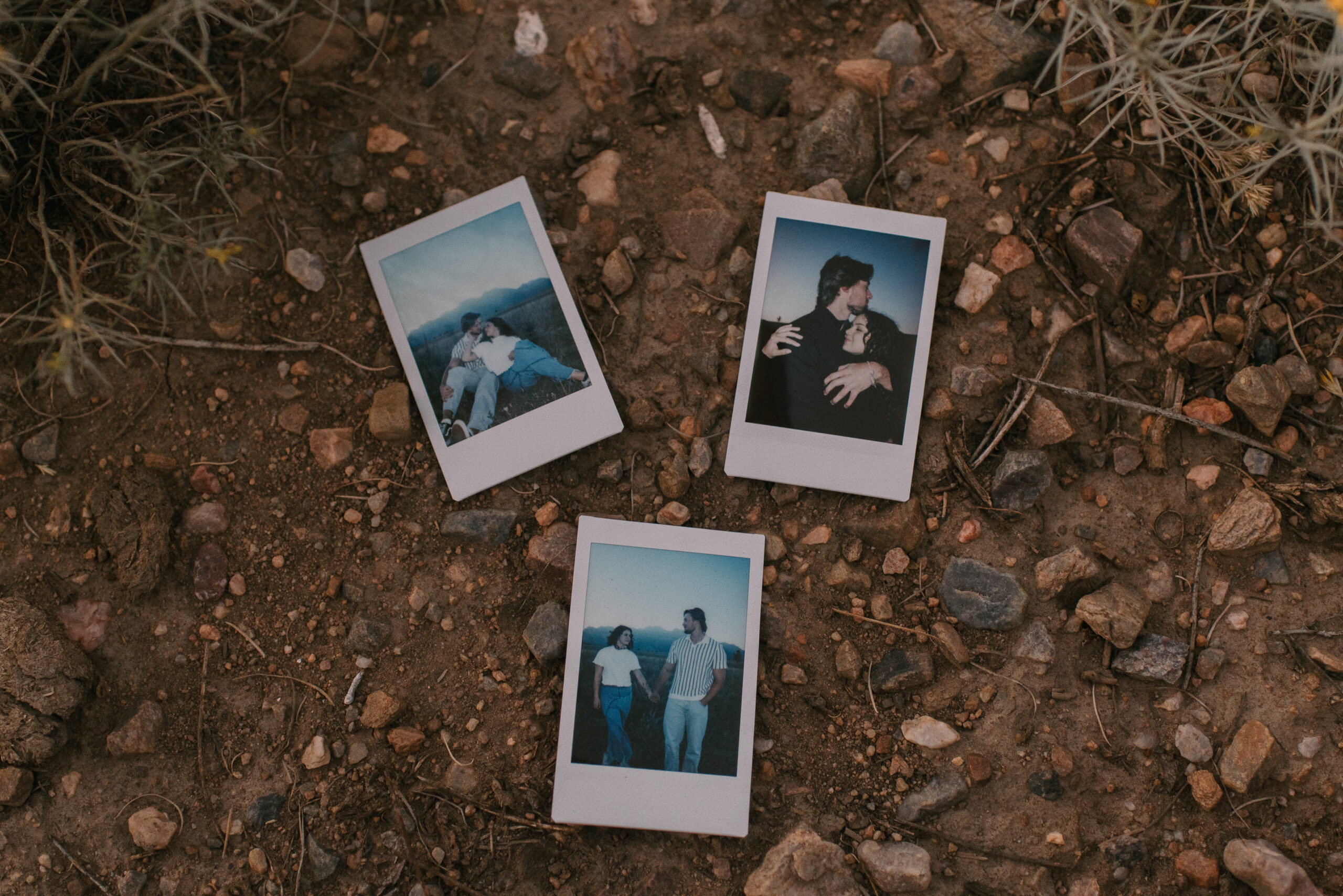 polaroid pictures from the couples photoshoot laying on the ground