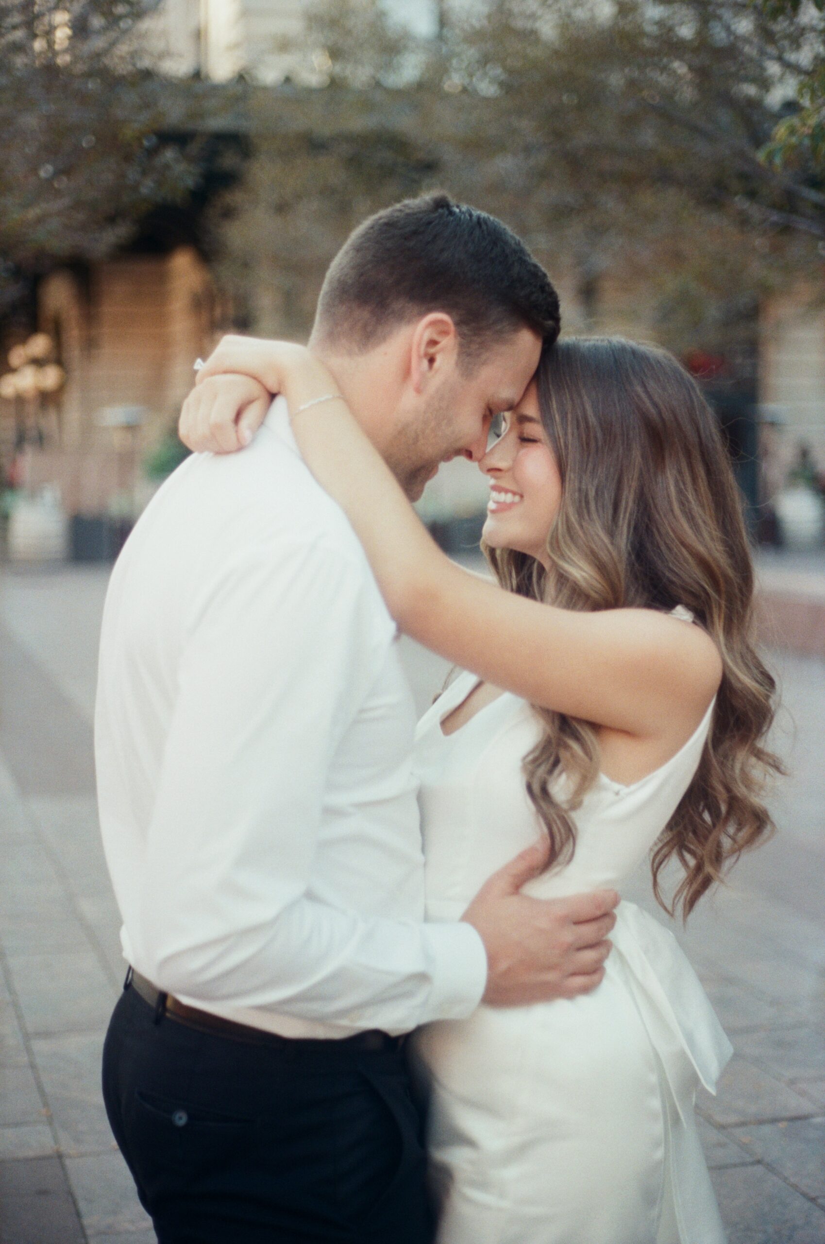 wedding film photography of bridal couple hugging in downtown denver