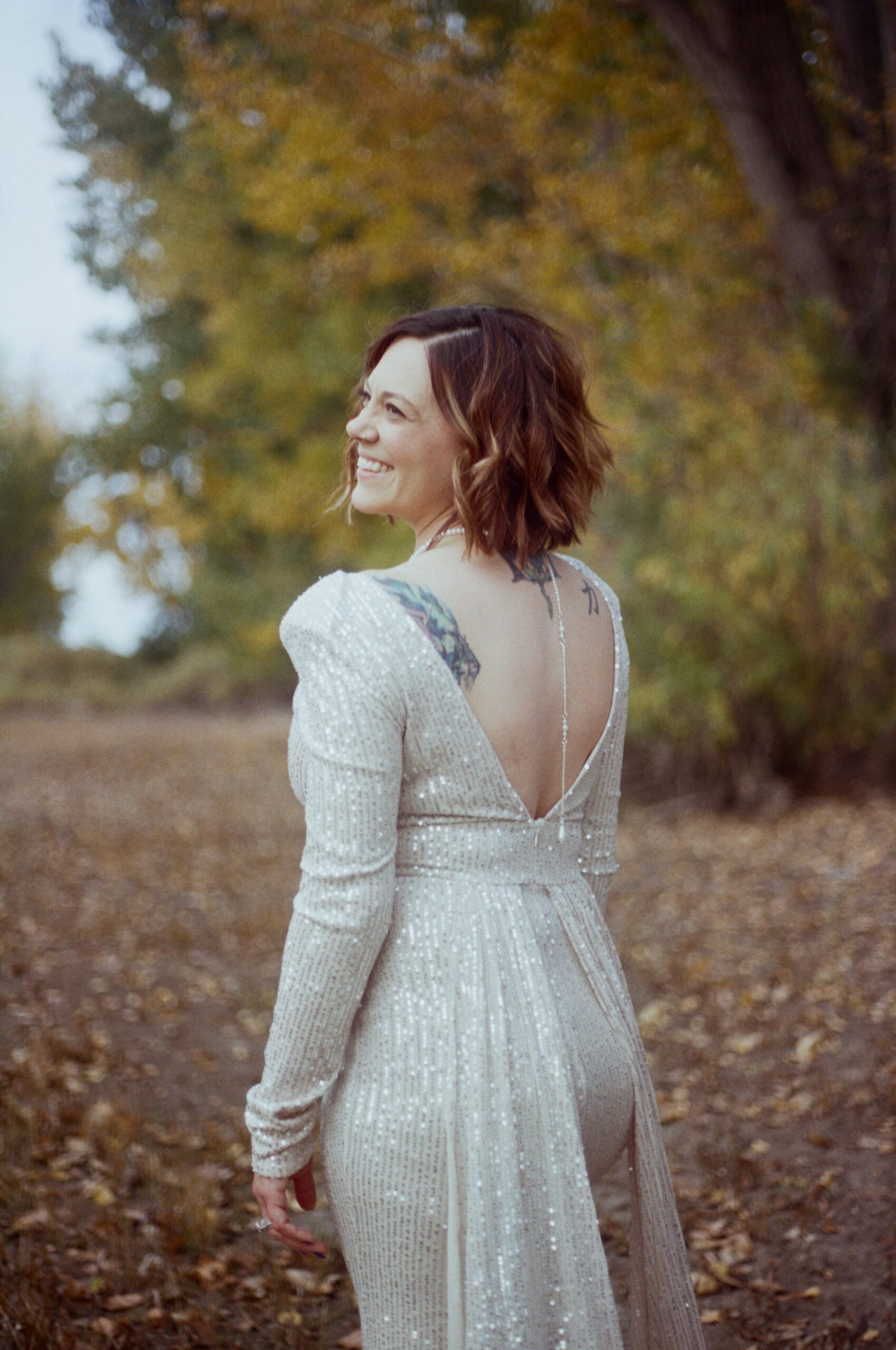 woman smiling with an open back dress on 