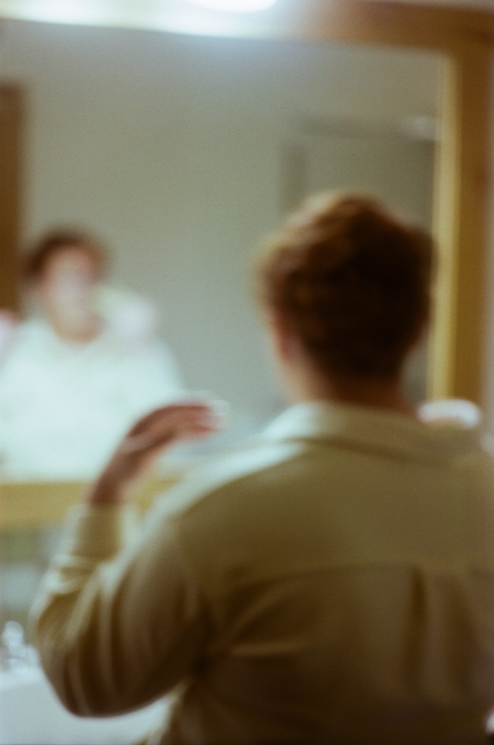 out of focus film photo of a bride getting ready 