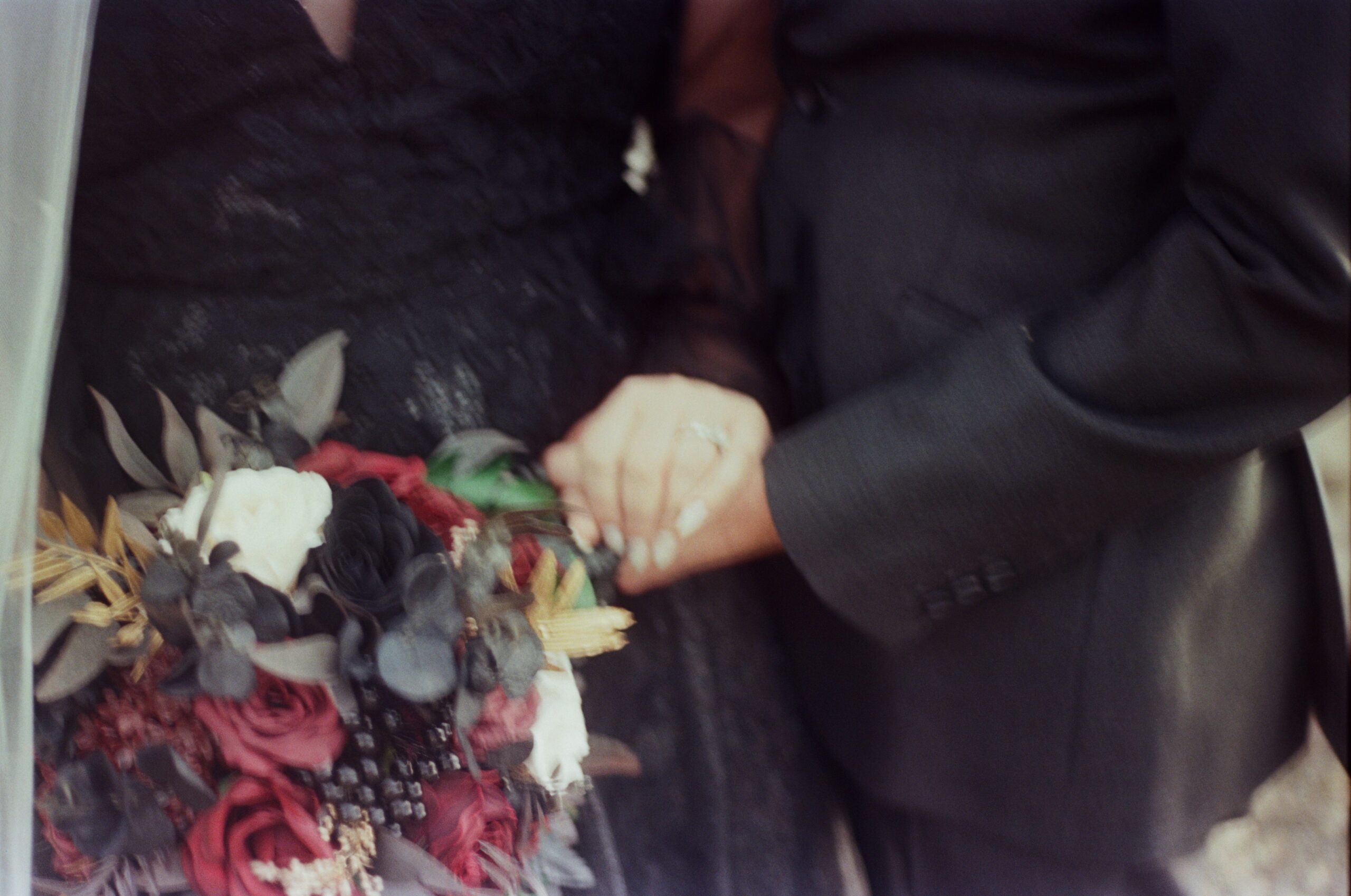 wedding film photography close up of wedding couple holding hands 