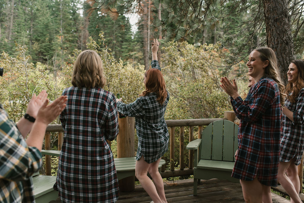 bride and bridesmaids dancing in flannel shirts