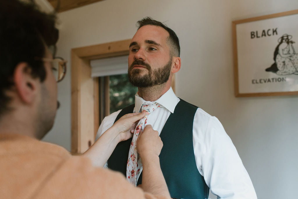 groom getting help with his tie