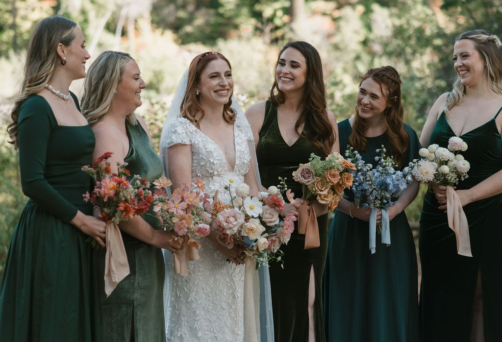 the bride and her bridesmaids with their colorful bouquets showing the bride's personalized wedding detail choices