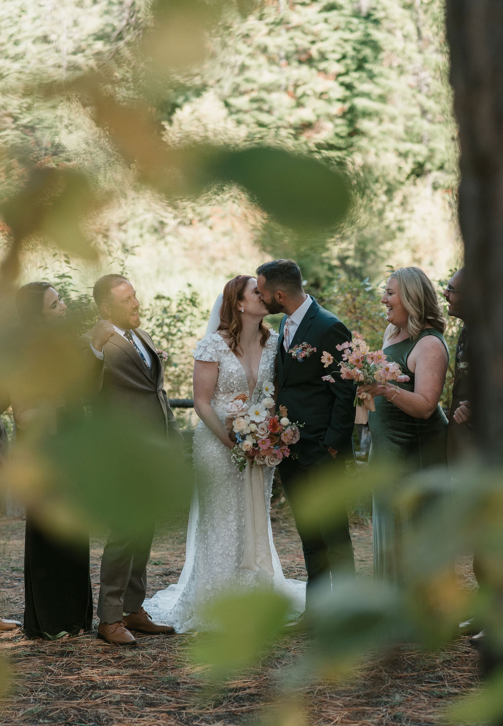 bridal couple kissing captured through the trees