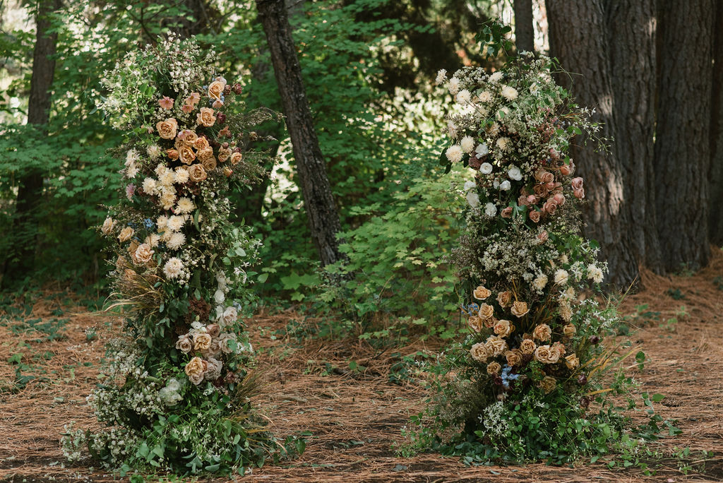 the colorful floral arch in the woods