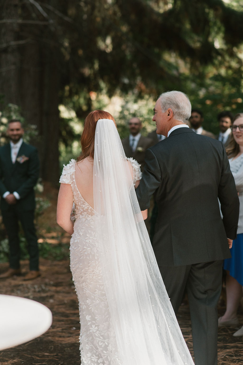 bride and dad walking down ceremony aisle 