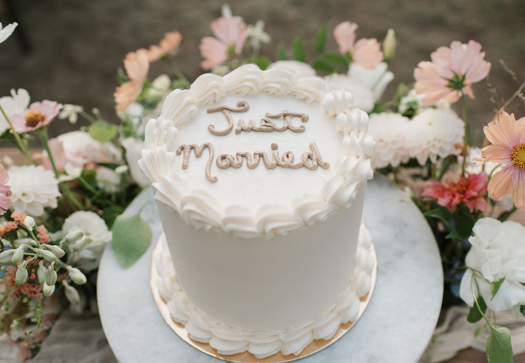 personalized wedding detail shot of wedding cake and florals 