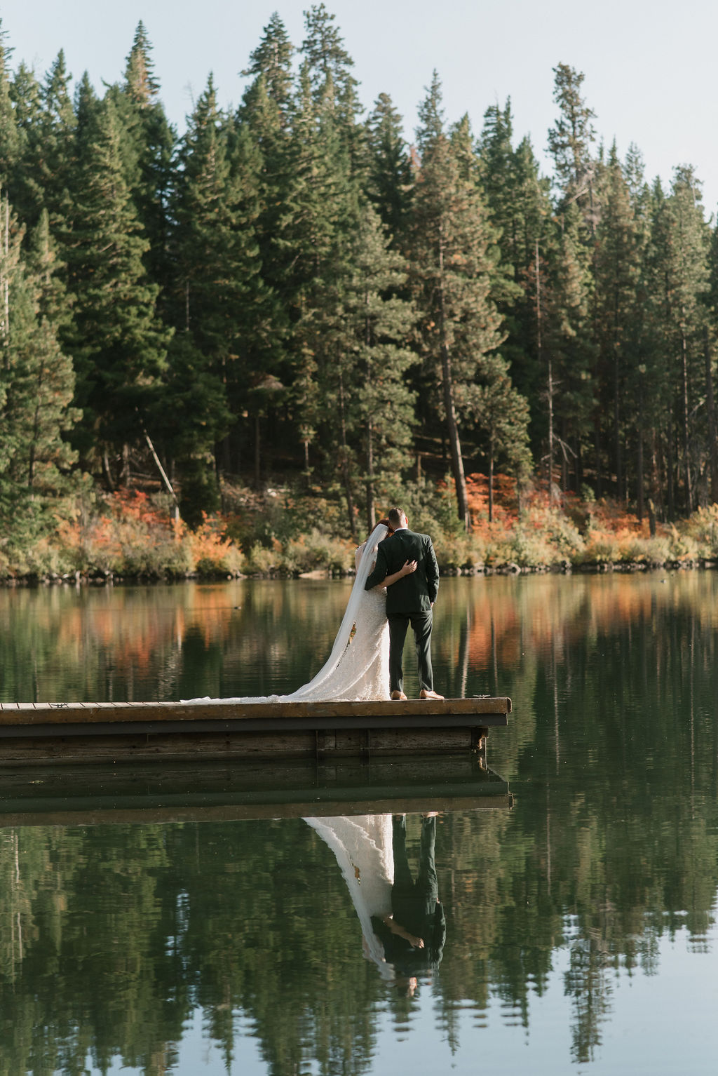 newly wed couple standing on a dock in oregon
