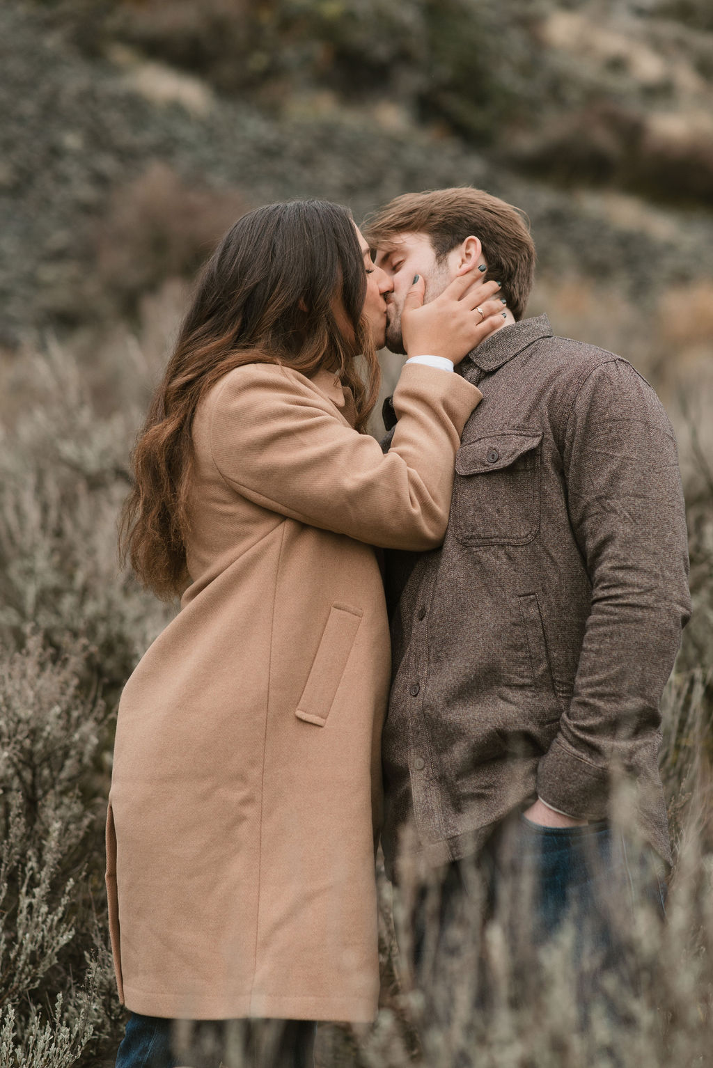 newly engaged couple kissing during their outdoor modern engagement pictures