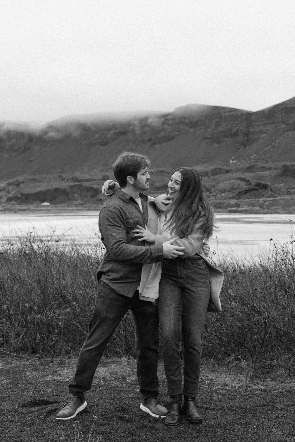 newly engaged couple dancing together on the trail during their modern engagement pictures