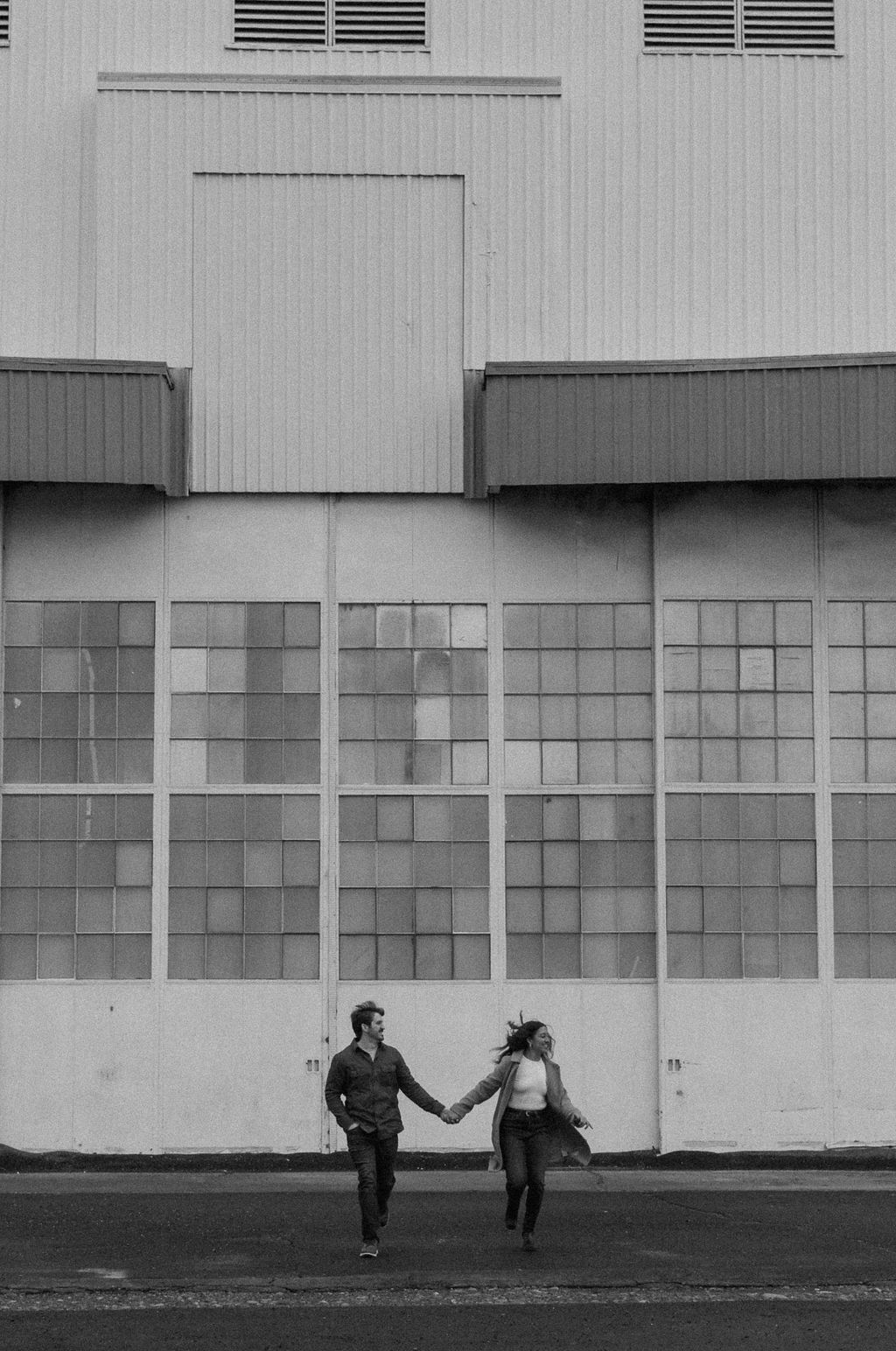 couple holding hands and running 
