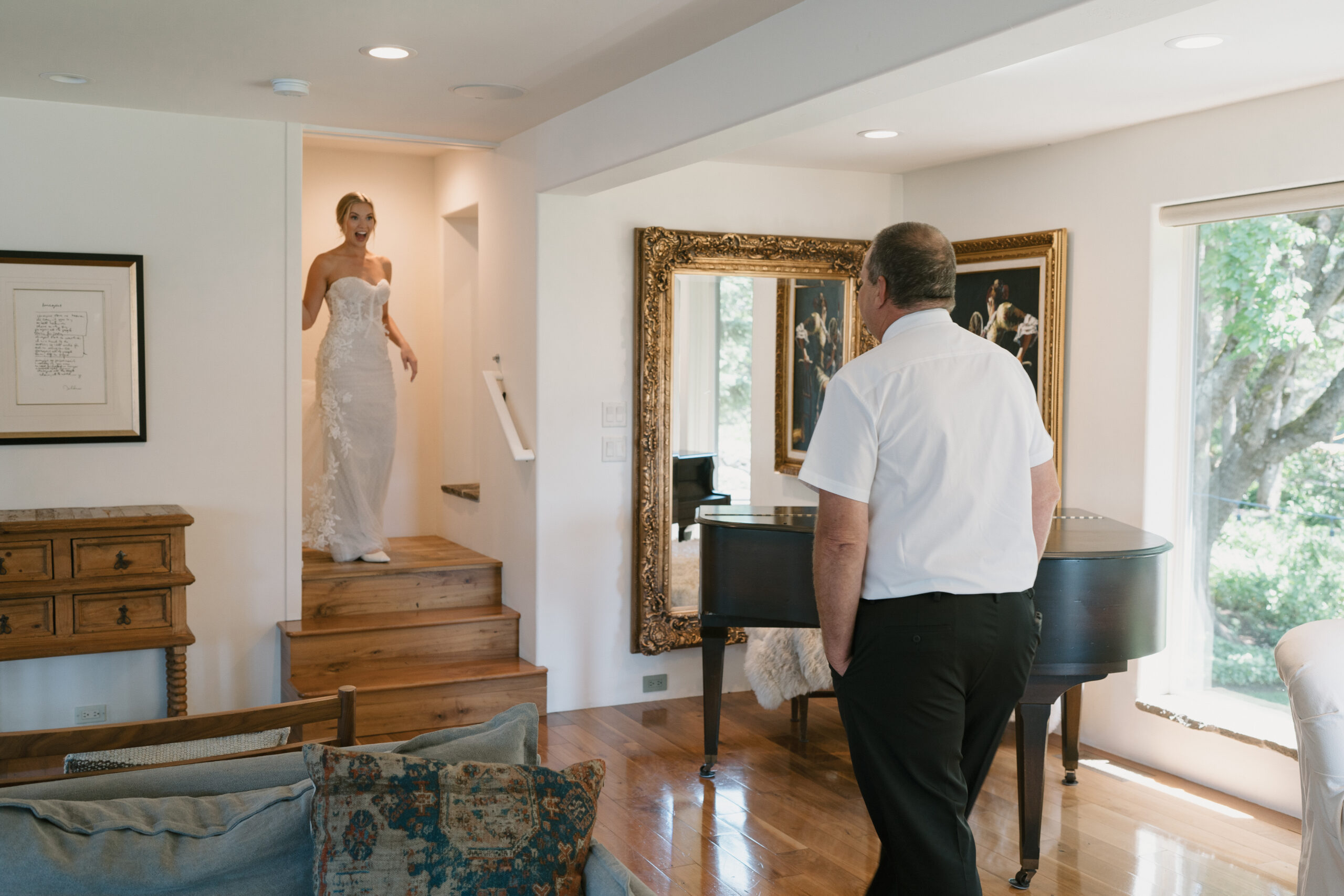 Father and bride have a first look while coming down the stairs in The Griffin House