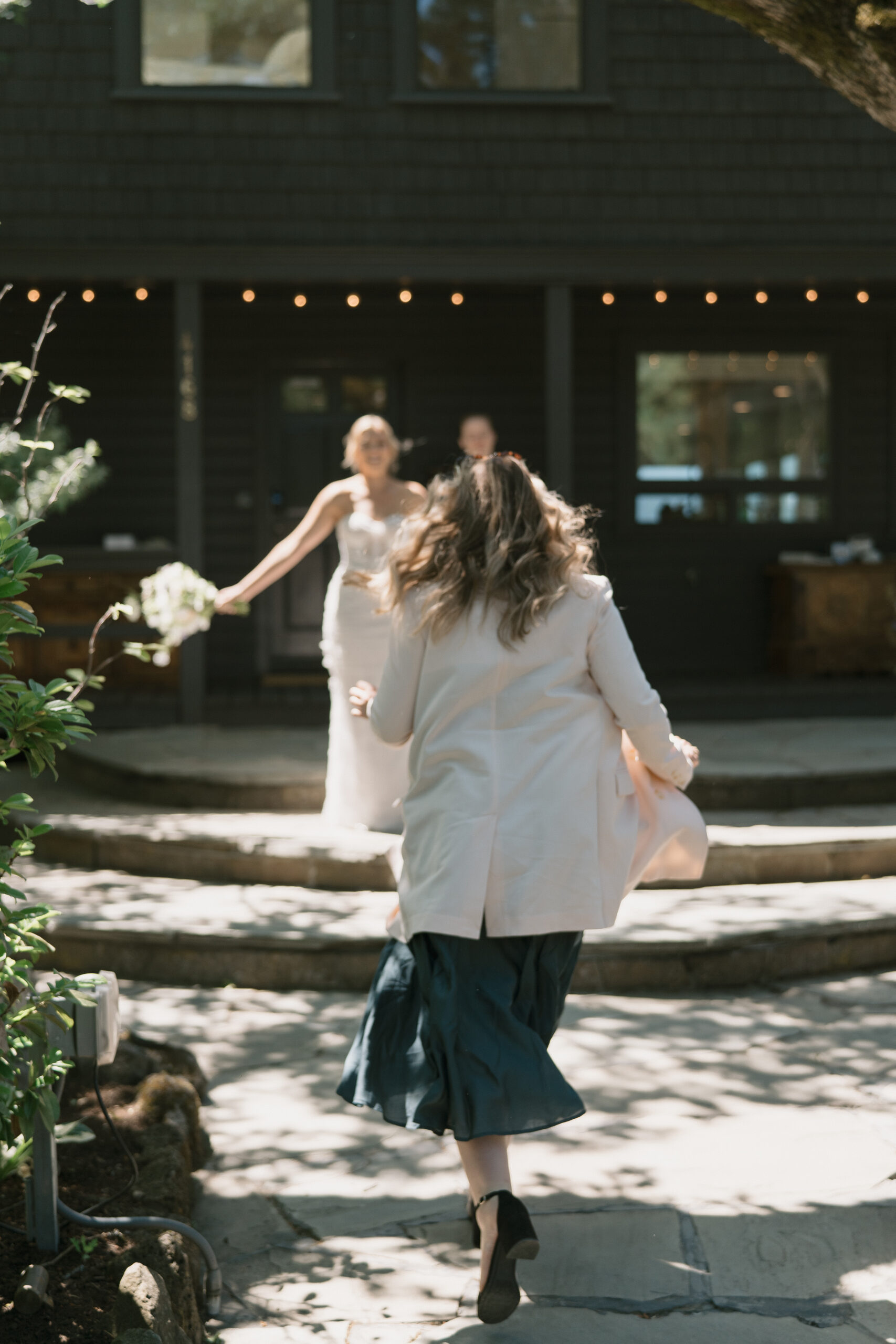 A close friend running to go greet the bride for the first time on her wedding day