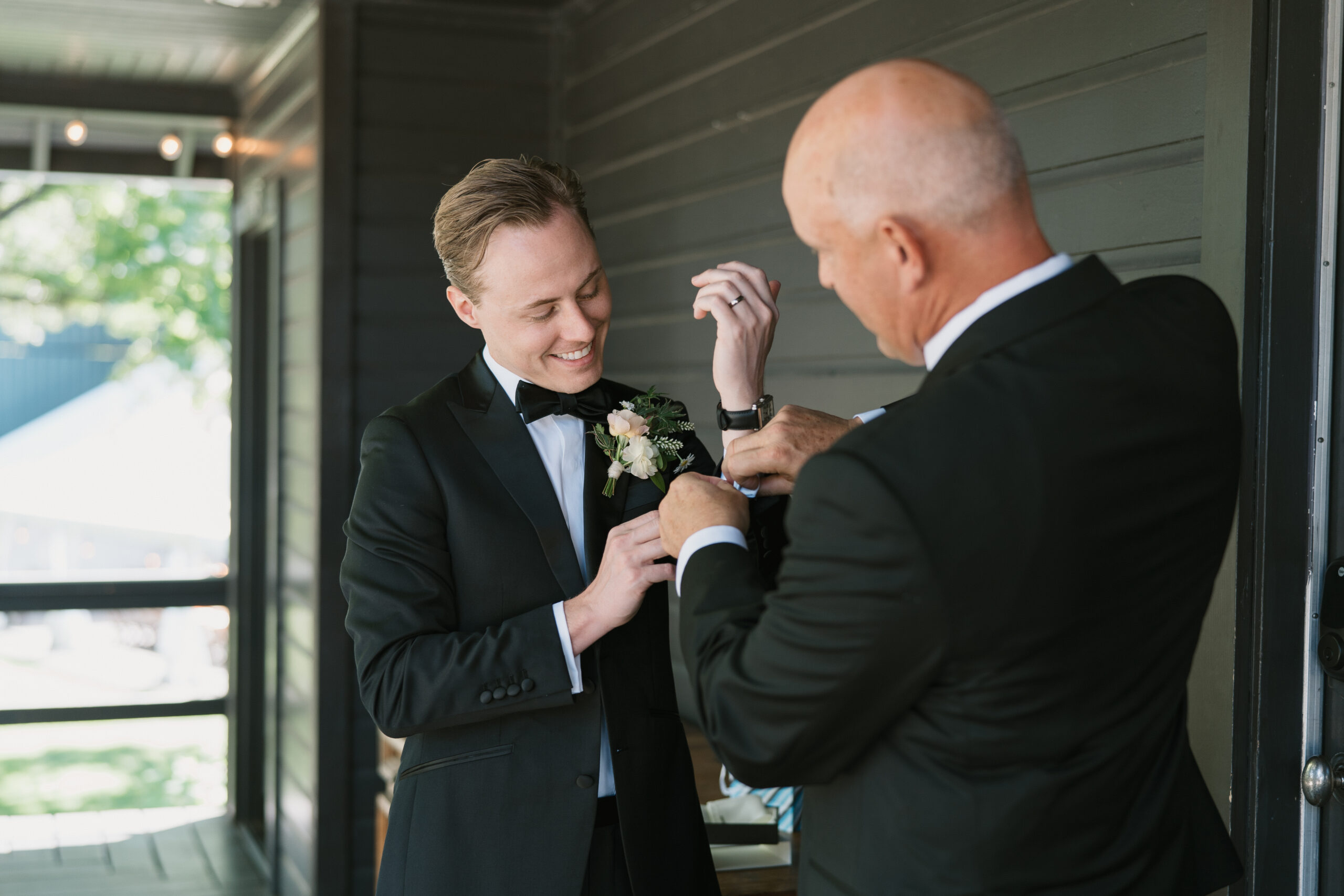 The groom's father putting on special cuff links