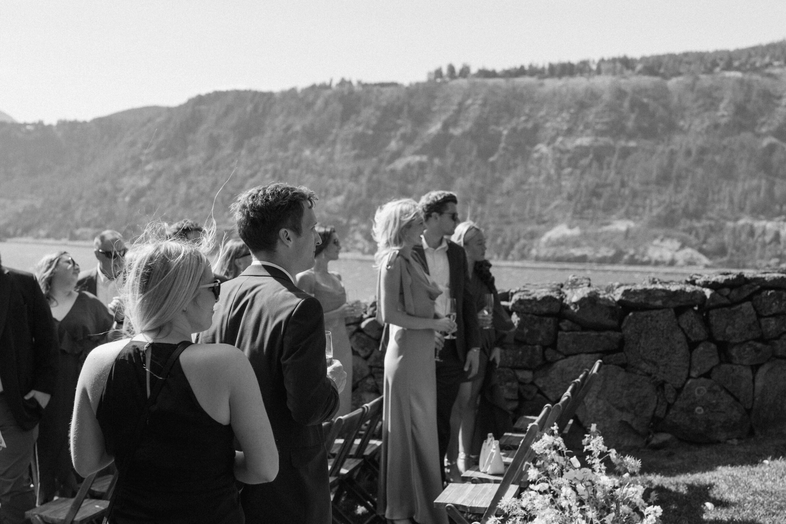 a black and white of the guests waiting for the bride to walk down the isle