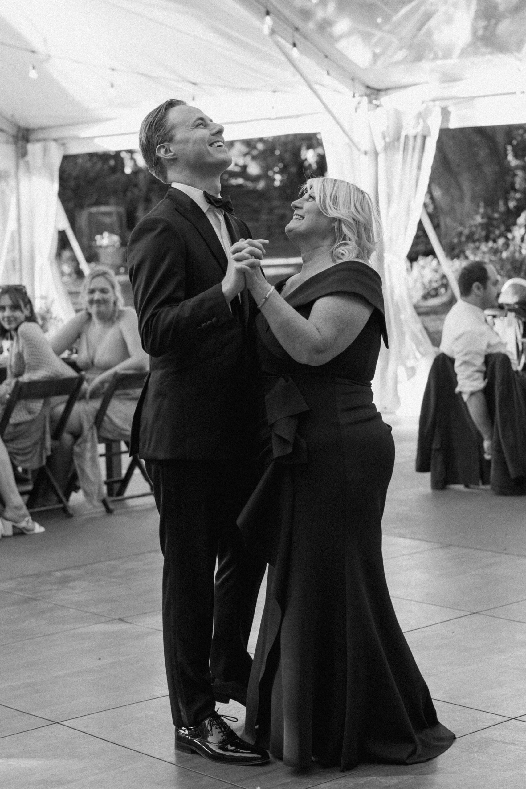 black and white photo of the groom dancing with his mother