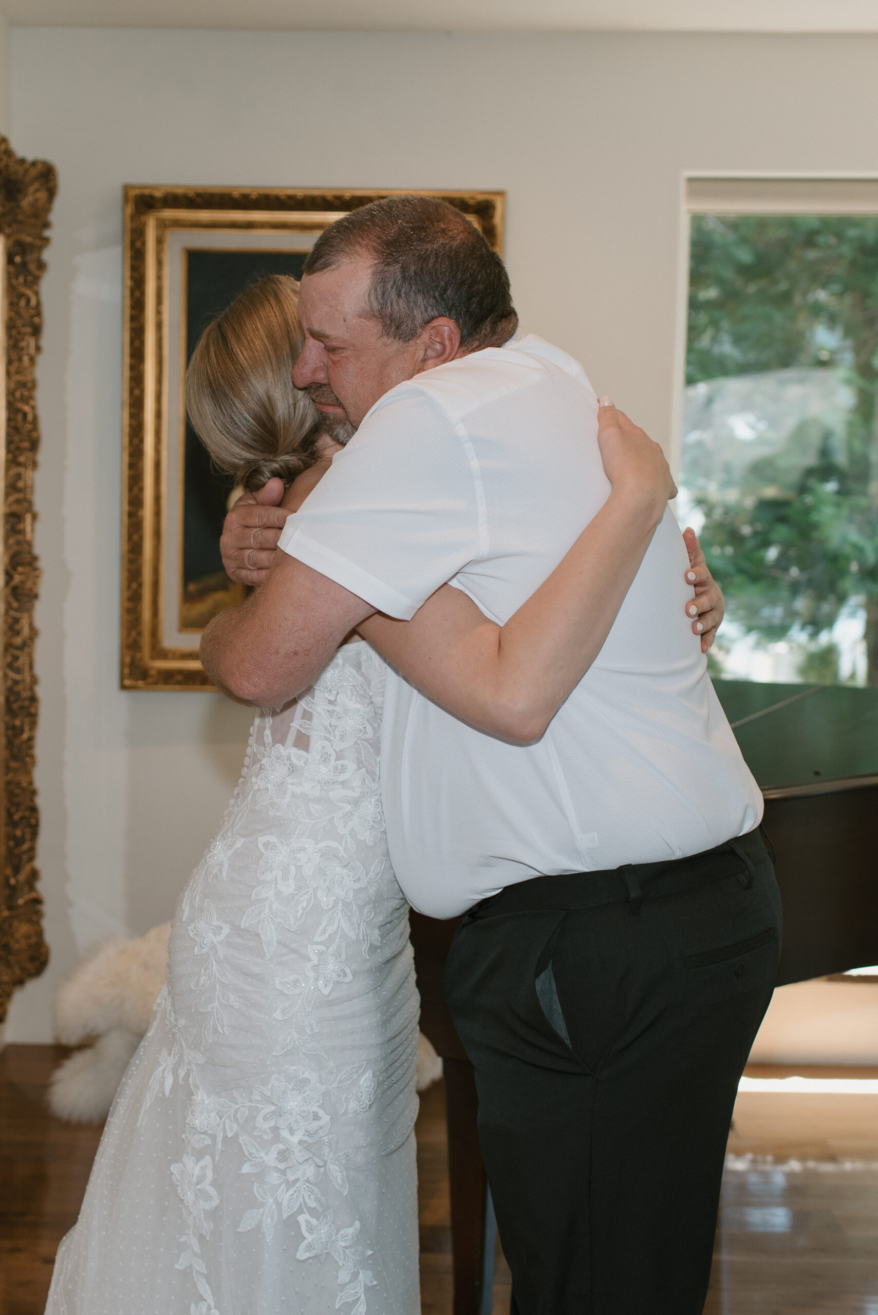 Bride and father embrace after first look