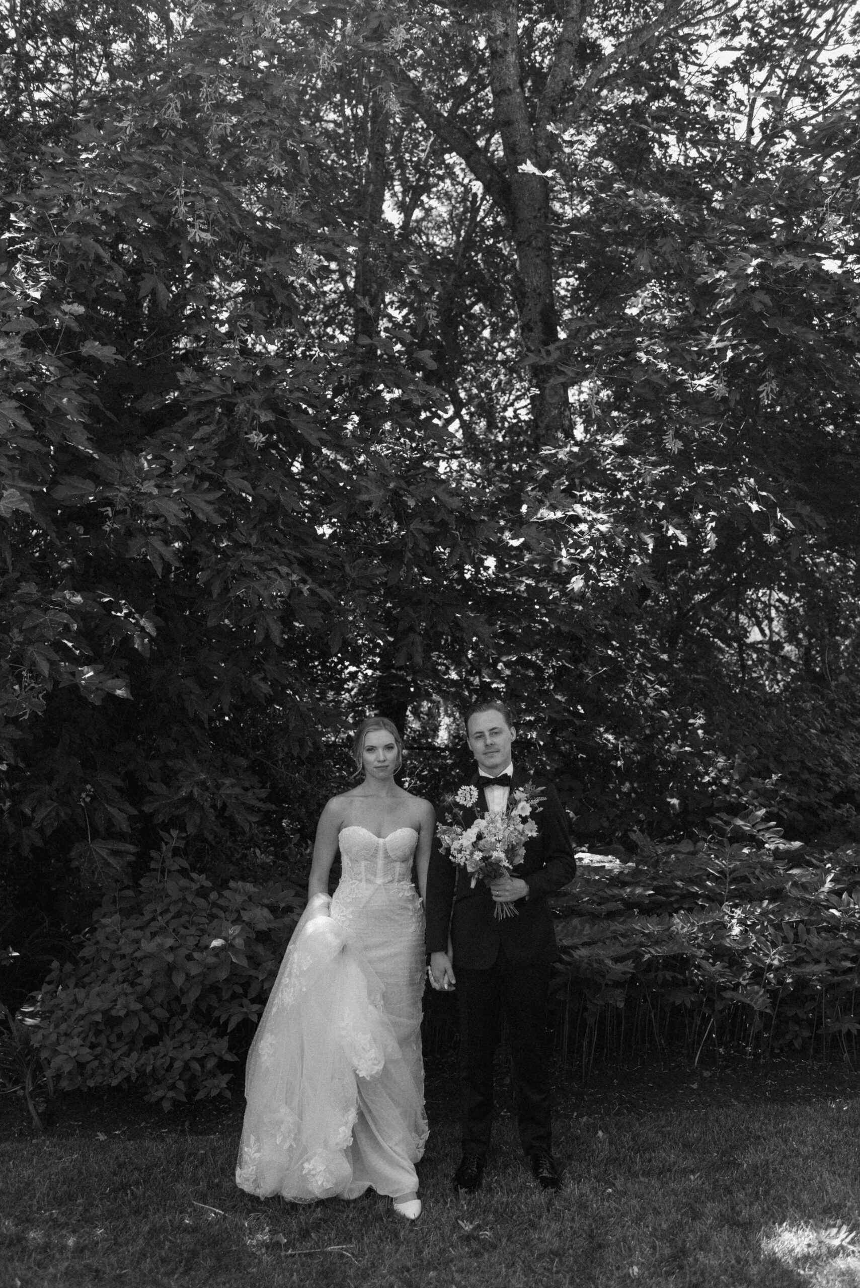 An editorial black and white photo of the bride and groom at The Griffin House