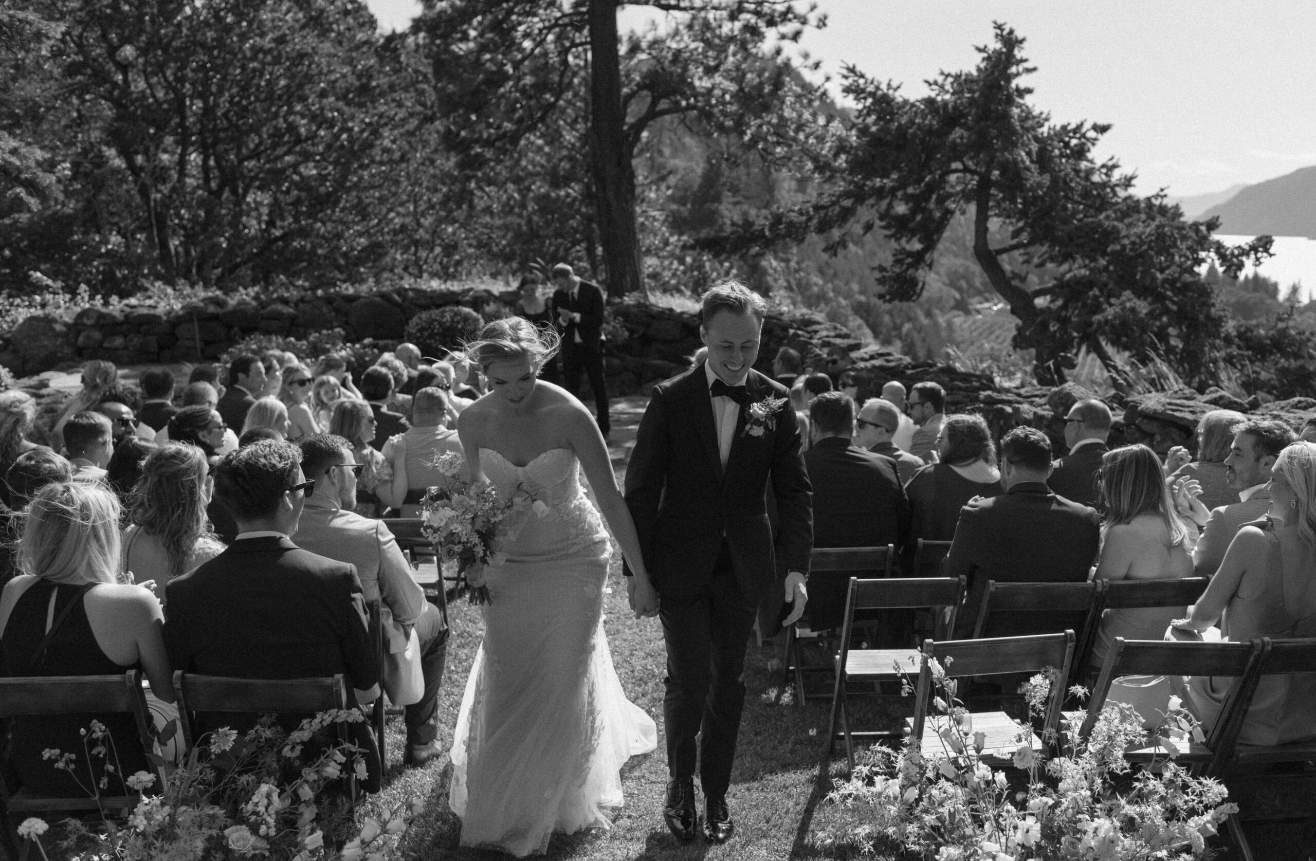 Bride and groom walking back up the isle after getting married at The Griffin House