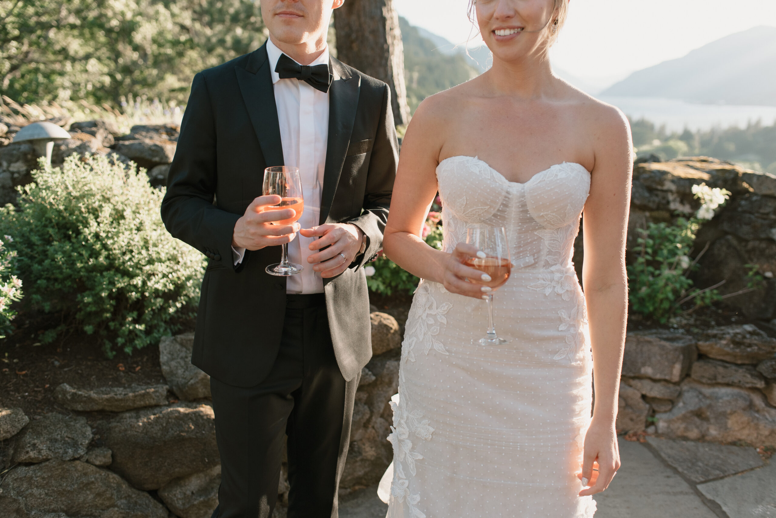 bride and groom enjoying two glasses of wine together