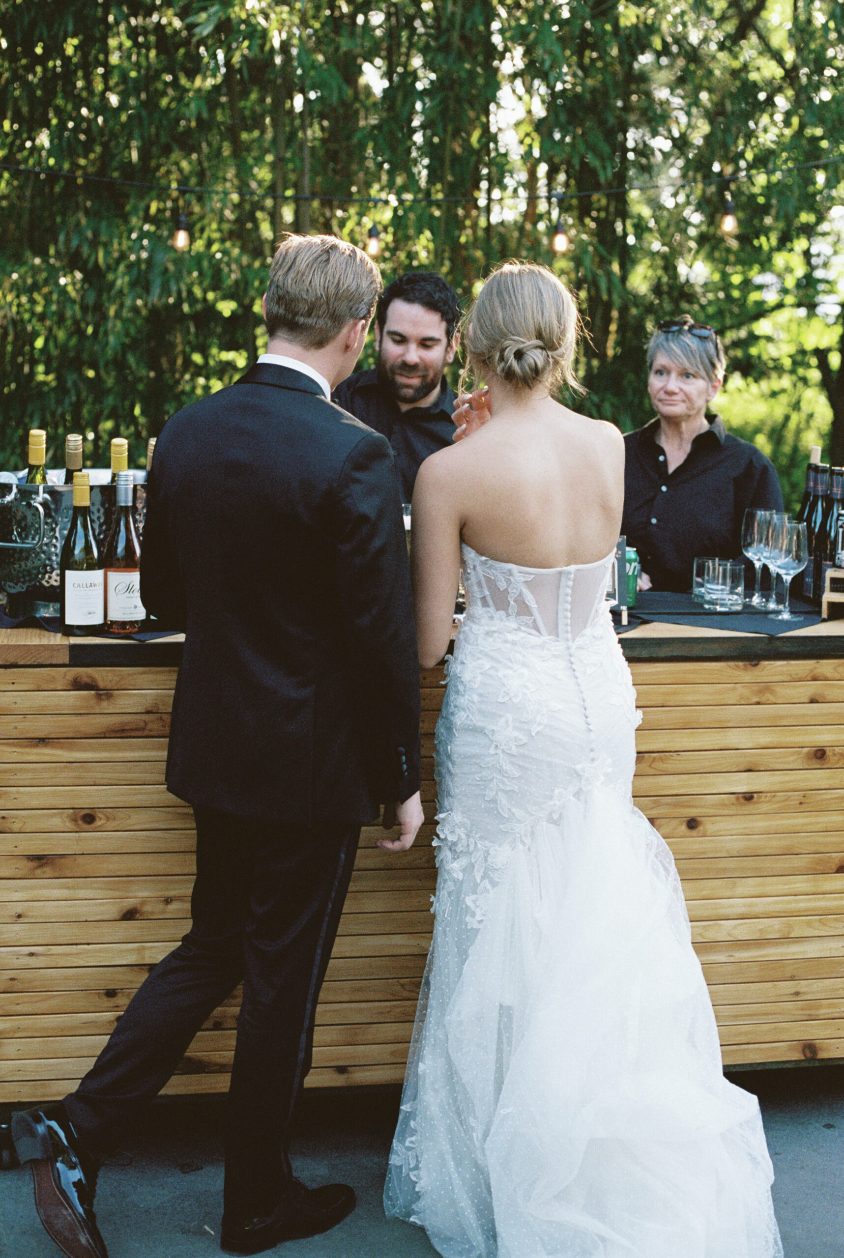 bride and groom at the bar getting a cocktail together