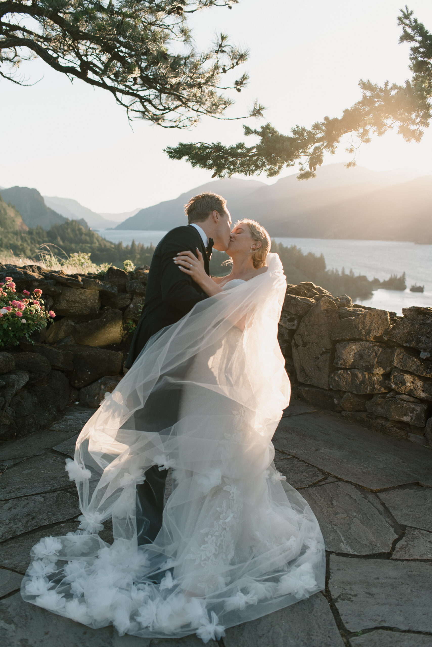 bride and groom doing a dip kiss at sunset overlooking the Columbia river gorge at The Griffin House